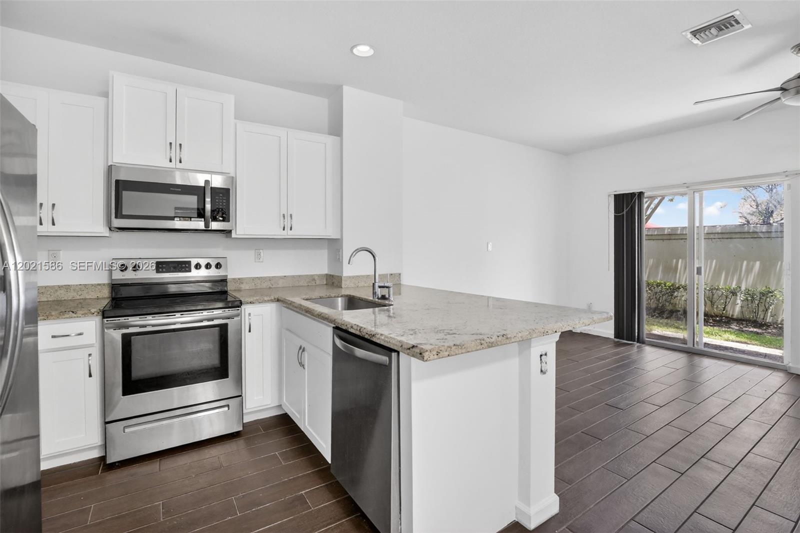 Rarely available corner-unit townhome in a the all ages, gated community CRICKET CLUB, featuring 3 bedrooms, 2.5 bathrooms, and a bright, modern layout filled with natural light. FRESHLY PAINTED. All New flooring on 2nd floor. The spacious first floor offers open-concept living and dining areas alongside a sleek contemporary kitchen with stainless steel appliances and upgraded cabinetry with granite counters. Upstairs, the primary suite features a walk-in closet and a comfortable private retreat feel, while all bedrooms offer generous space and abundant natural light. Additional highlights include tons of storage throughout and a dedicated laundry room for added convenience. Enjoy a private patio perfect for relaxing or entertaining outdoors. Complete with a 1-car garage, two driveway spaces, and nearby guest parking. Ideally located in the heart of Broward County just minutes from beaches, Florida Turnpike & other Florida highways, Fort Lauderdale Hollywood International Airport, Las Olas, shopping, dining, and entertainment. Beautifully maintained and truly move-in ready.