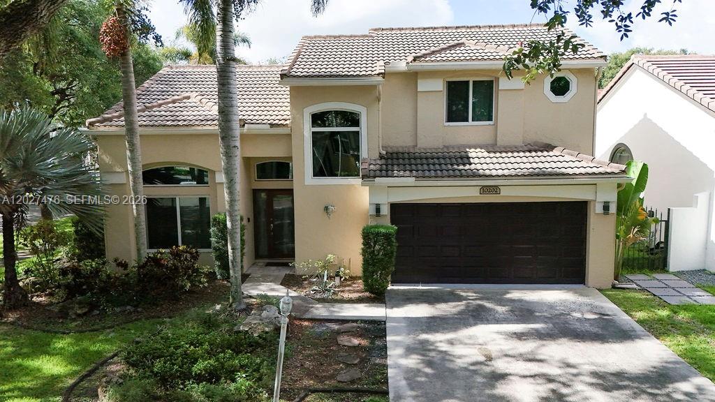 Welcome to Embassy Lakes, one of Cooper City's most sought-after gated communities. This beautifully updated home features soaring ceilings, rich wood flooring, impact windows, and a spacious open layout designed for modern living. The chef's kitchen offers Shaker-style cabinetry, granite countertops, and a large island perfect for entertaining. The first-floor primary suite provides privacy and convenience, while two oversized upstairs bedrooms share a Jack & Jill bath. Recent AC with smart thermostat. Enjoy a private, low-maintenance patio and resort-style amenities including pool, fitness center, tennis and basketball courts. Top-rated schools, prime location, and move-in ready—schedule your private tour today!