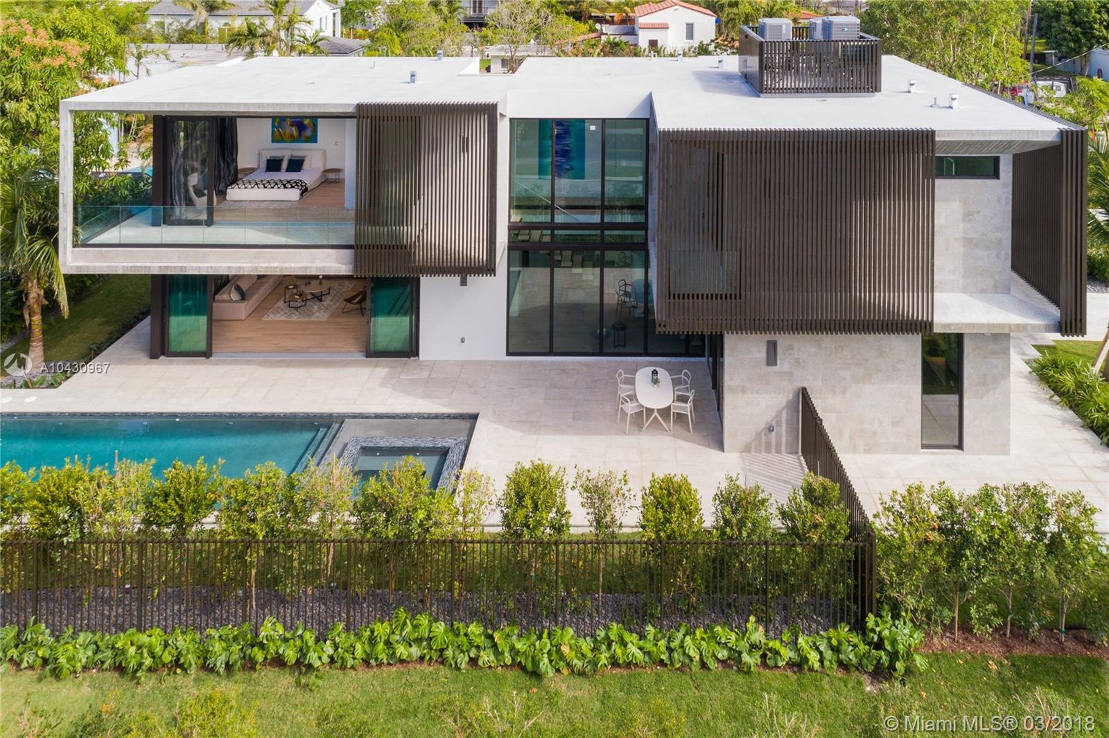 New modern luxury home on the Venetian Islands of Miami Beach. Completed in 2018 & designed By Ruben Gomez of AI2 Design, this masterpiece has the ultimate mix of sharp & dramatic contemporary appeal with warm tones & finishes to create the ideal harmonious atmosphere. Featuring lighting designed by Porche Design Studio By Apure, a large living room overlooking the pool, a formal dining next to an interior garden, a high-end kitchen with Ital-Kraft cabinets, a cooking island, & SubZero/Wolf appliances. Wall-to-wall sliding doors open-up completely to create the ideal indoor/outdoor entertaining experience. Upstairs, four bedrooms with en-suit baths & large closets, including a master with a big terrace, walk-in closet, & luxe bath. Outside, a heated pool with built-in spa.