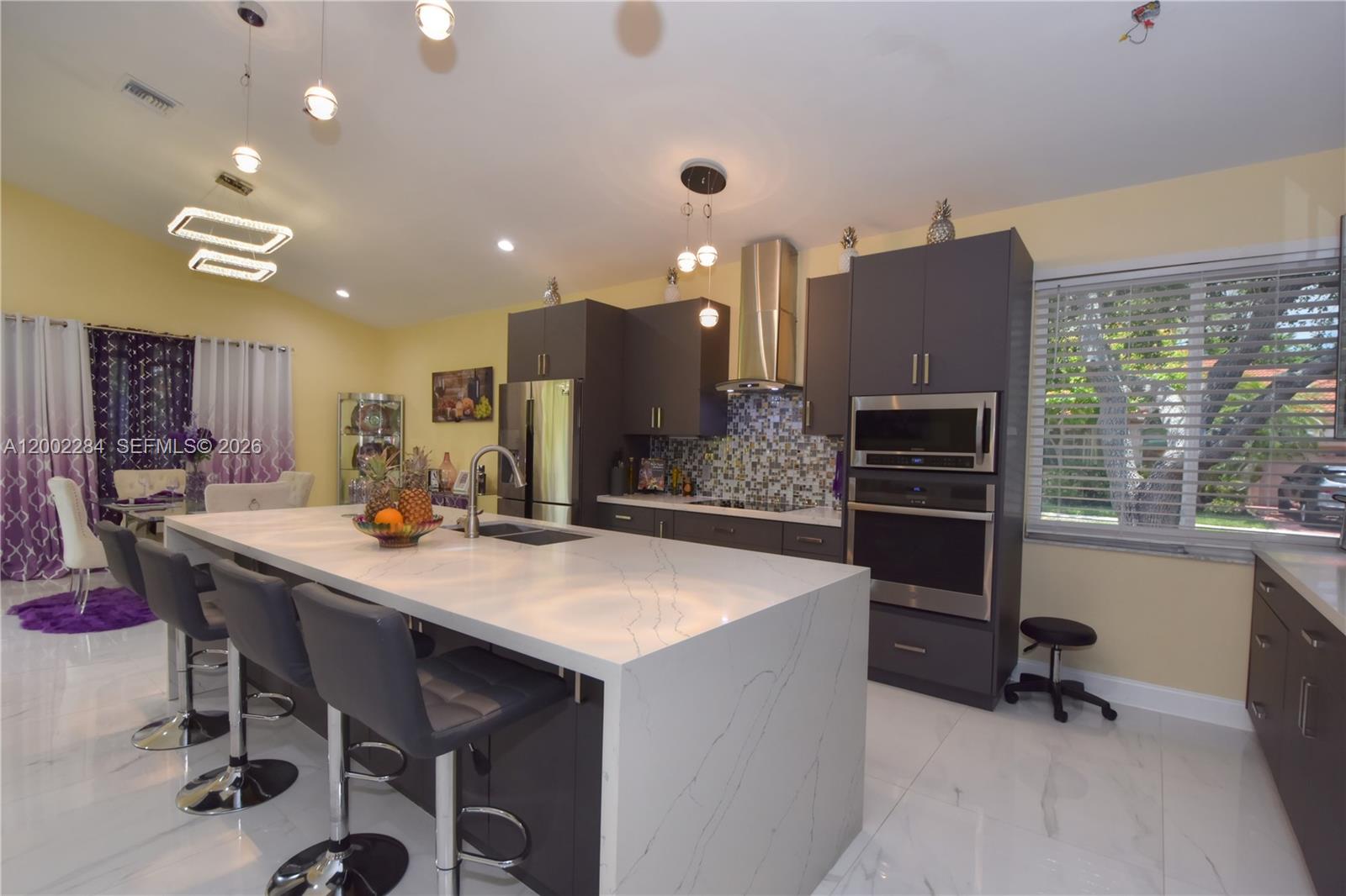 MAKE TIME TO SEE THIS BEAUTY IN TAMARAC BEFORE SOMEONE ELSE DOES!!!  STEP INTO LUXURY WITH THIS STUNNING 3 BEDROOM 2.5 BATH BLING HOUSE WHERE EVERY CORNER EXUDES OPULENCE AND SOPHISTICATION. NESTLED IN DESIRABLE GATED WOODMONT GREENS IN TAMARAC, THIS HOME BOATS CONTEMPORARY ELEGANCE WITH EXTRAVAGENT FINISHES FROM THE MINUTE YOU ENTER. WHITE TILE FLOORS LEAD TO OPEN CONCEPT FEATURING CHEFS DREAM KITCHEN WITH QUARTZ COUNTERS, RECESSED LIGHTING, CUSTOM CABINETS, STAINLESS STEEL APPLIANCES, PERFECT FOR LARGE PARTIES OR INTIMATE GATHERINGS. LIVING ROOM WITH FLOOR TO CEILING WINDOWS AND DOORS ALLOWING LOADS OF NATURAL LIGHT. LUXURIOUS MASTER FEATURING CUSTOM WALK-IN CLOSET, SITTING AREA. ENSUITE SPA LIKE BATH WITH WALK IN SHOWER, DUAL SINKS. 2 ADDITIONAL BEDROOMS WITH SHARED BATH. HALF BATH, 2 CAR GARAGE, YARD REMOVED FOR YOUR CONVENIENCE, IMPACT WINDOWS AND DOORS. ROOF 2020, TANKLESS WATER HEATER. THIS HOME MAKES EVERYDAY FEEL LIKE A LAVISH RETREAT - COME EXPERIENCE IT FOR YOURSELF - YOU WONT BE DISAPPOINTED!!