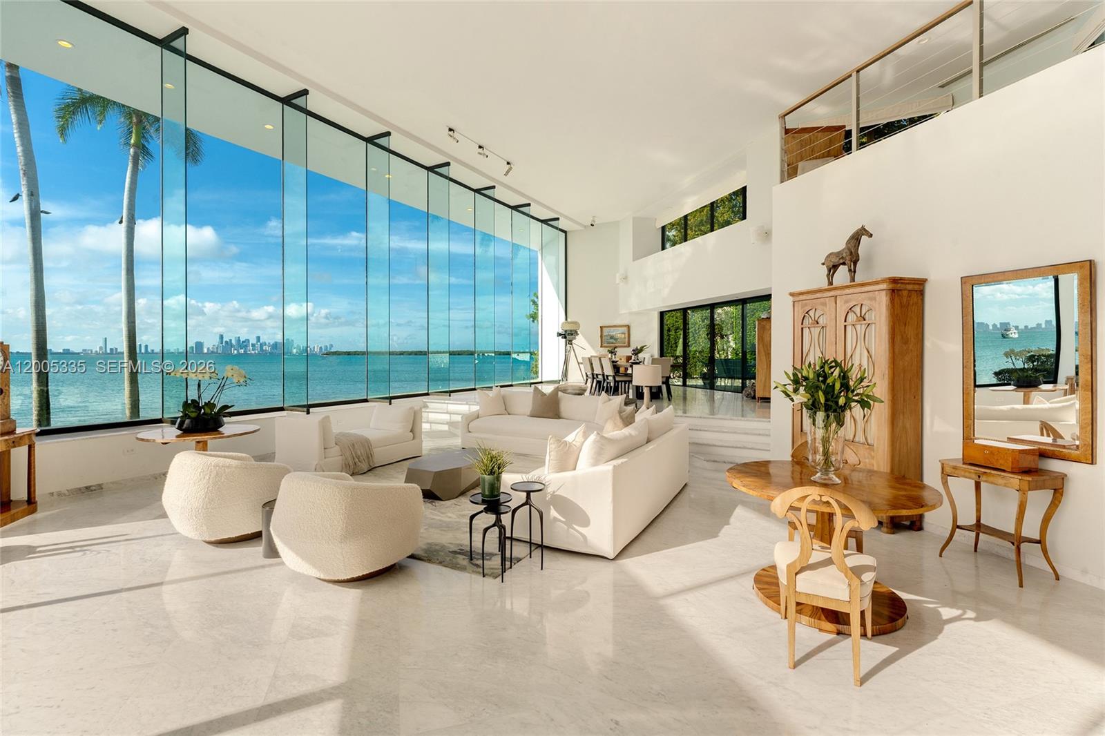 485 W Matheson Drive is one of America’s most iconic waterfront estates, representing a rare convergence of presidential history, cinematic legacy, and unparalleled waterfront scale. Set on approximately 2.38 acres with an extraordinary 862’ of direct Biscayne Bay frontage, the property captures sweeping, unobstructed views of the Miami skyline and open bay, offering a level of presence and exclusivity rarely found in South Florida. Once the “Winter White House” of, the estate also achieved cinematic fame as the Frank Lopez residence in Scarface, with original architectural elements still preserved, including the iconic glass elevator. Offers 5BR + gym (can be converted to 6th BR) 7+2BA, and approximately 13,500 SF (per owner) across three levels, featuring soaring 24’+ ceilings, marble floors, and walls of glass framing breathtaking bay views. Expansive living, dining, and kitchen areas open to large terraces, creating seamless indoor-outdoor living ideal for both everyday comfort and grand-scale entertaining. Resort-style grounds include a piano-shaped saltwater pool, cabana bath, lush tropical landscaping, and expansive lawn areas with artfully integrated lighting extending the estate’s experience well beyond sunset. A private marina, formerly a presidential helipad—features rare 3-phase power and dockage for yachts up to 200’, plus over 34,000 SF of submerged land, making this one of Miami’s most significant and irreplaceable waterfront holdings in the world.