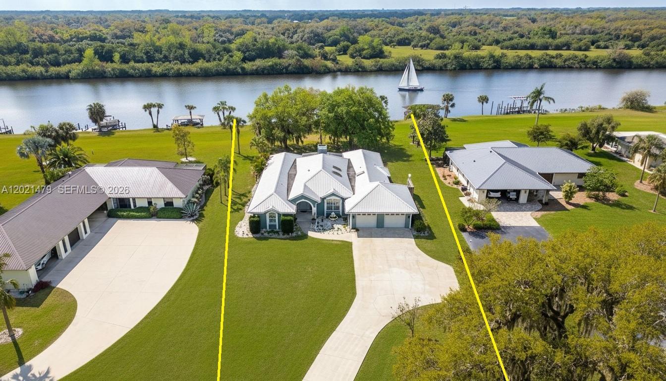 Experience fantastic waterfront living in Riverbend Estates, one of LaBelle’s premier communities. This beautiful home sits directly on the Caloosahatchee River (Intracoastal Waterway) and includes a private deep-water dock with direct access to the Gulf, Lake Okeechobee, and the Atlantic Ocean. Inside, an open, light-filled layout features hardwood floors, a fireplace, and sweeping river views. The remodeled kitchen showcases quartz countertops, stainless steel appliances, and modern finishes. The primary suite serves as a private retreat with dual vanities, a soaking tub, a walk-in tile shower with dual shower heads, and an oversized walk-in closet. A screened lanai overlooks the river, creating the perfect spot to unwind and watch boats pass by. Whether you’re into boating, fishing, or waterfront relaxation, this property makes it effortless. Riverbend Estates offers resort-style amenities—community pool, clubhouse, and recreation center—with a low $330/month HOA covering water, sewer, lawn care, irrigation, and full access to community facilities. Waterfront opportunities like this are rare in LaBelle. Claim your slice of paradise on the river.