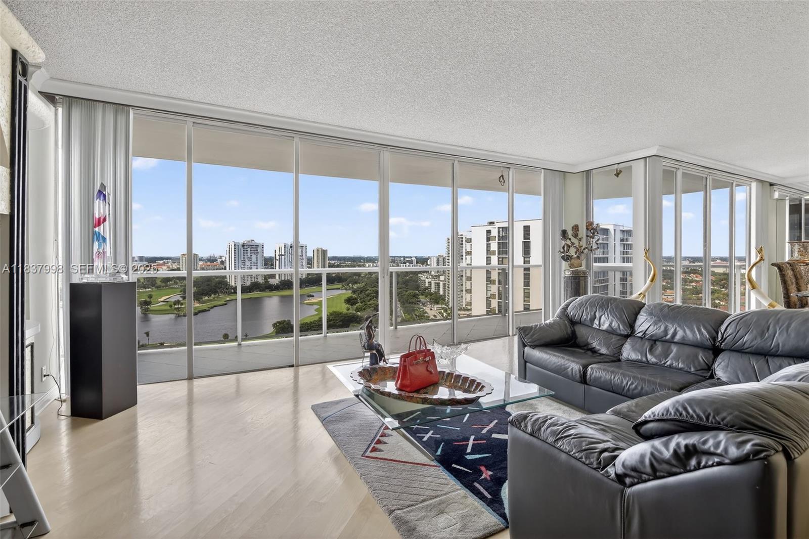 ENTER THROUGH DOUBLE DOORS & SEE THE BEST VIEWS OF THE GOLF COURSE, INTRACOASTAL, & CITY. SPACIOUS 1800SF CORNER UNIT W/WRAPAROUND BALCONY FOR SUNSET VIEWS. FINISHES INCLUDE WOOD FLOORS, GRANITE COUNTERS, ITALIAN MURANO, CUSTOM CLOSETS. NEW CUSTOM KITCHEN W/ALL NEW APPLIANCES, NEW BATHROOMS. SPACIOUS SPLIT BEDROOM PLAN. 
RESORT STYLE AMENITIES: POOL WITH HUGE DECK & BBQ, GYM, MEDIA RM, LIBRARY, EVENT ROOM, ENTER CLUB HOUSE TO THE SECOND POOL ON THE INTRACOASTAL, NEW GYM, SAUNA, SPA, RACQUETBALL & TENNIS COURTS, KIDS ROOM, CARD RM, ROOM SERVICE, FULL MOVIE THEATER, ALSO CAFE WITH OUTDOOR SEATING & MUCH MORE! CLOSE TO AVENTURA MALL, RESTAURANTS, CASINOS, 5 MIN TO THE BEACH, NEAR 2 INT'L AIRPORTS. NEXT TO SOFFER EXERCISE TRAIL ON GOLF COURSE. ALL ASSESSMENTS HAVE BEEN PAID BY SELLER.
