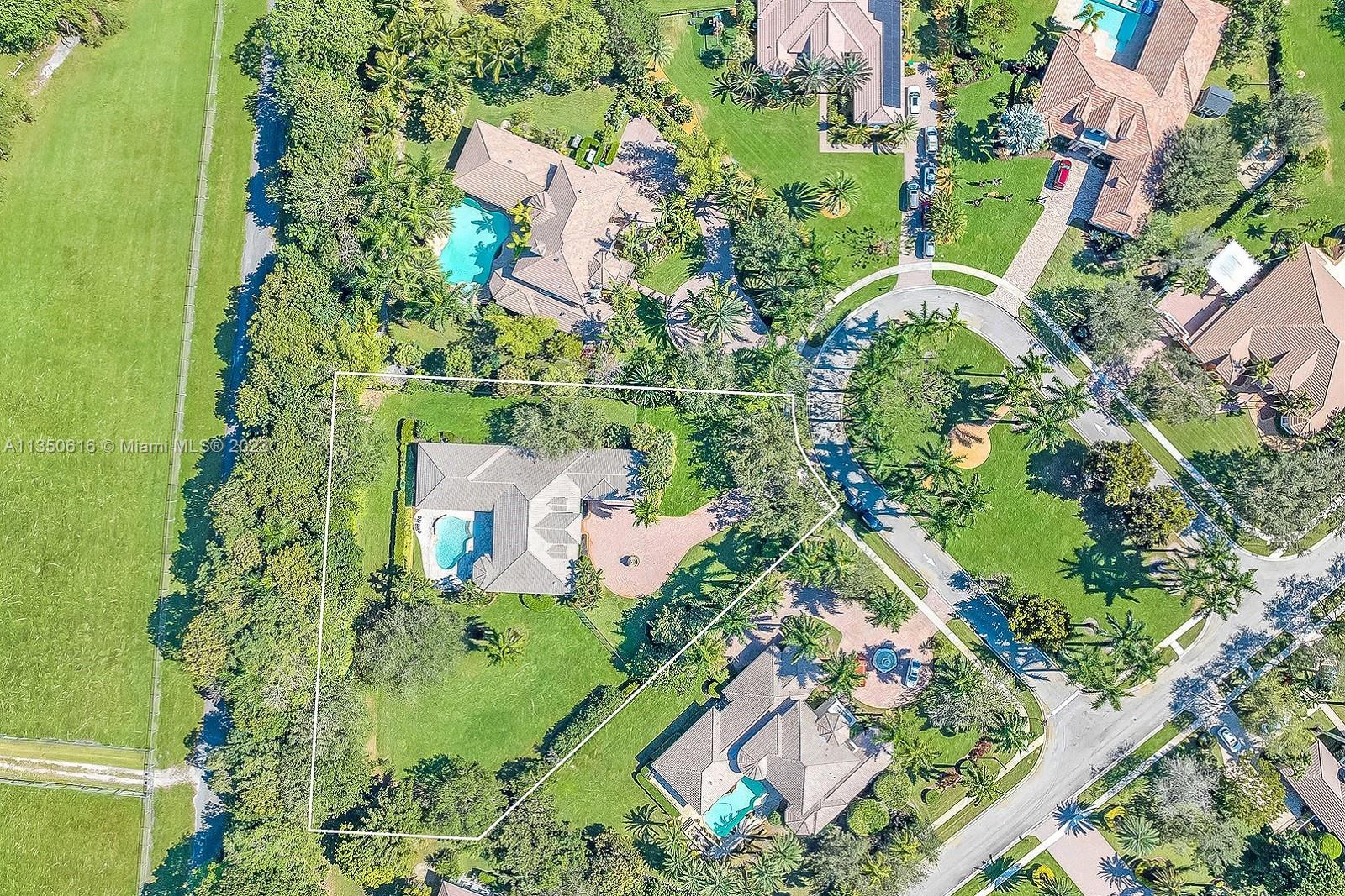 SET IN THE PRESTIGIOUS BOUTIQUE COMMUNITY OF GROVE CREEK RANCHES IN DAVIE, SPECTACULAR ESTATE BOASTS 5 BEDS, 4 BATHS & 4,126 SQ FT OF LUXURIOUS LIVING AREA AMID A SPRAWLING 44,808 SQ FT LOT. PRIVATE GATES OPEN TO A  ROUNDABOUT LEADING TO DOUBLE DOOR ENTRY. WELCOMING OPEN LIVING AREAS W CUSTOM TREY CEILINGS, MOLDINGS & STUNNING FIXTURES. GOURMET CHEF'S KITCHEN HAS TOP OF THE LINE THERMADOR APPLIANCES INCLUDING DOUBLE OVEN, GAS RANGE & WINE FRIDGE. SPLIT FLOOR PLAN HAS JR. SUITE W ENSUITE BATH. 2 OTHER BEDS W JACK & JILL. EXQUISITE PRIMARY SUITE HAS SITTING AREA & SPA BATH RETREAT W SOAKING TUB. IDEAL LAYOUT FOR ENTERTAINING, W/ FRENCH DOORS TO THE LANAI W OUTDOOR KITCHEN & TO PRIVATE GROUNDS OFFERING A FREE-FORM POOL W WATERFALL SURROUNDED BY LUSH LANDSCAPING. IMPACT GLASS IN FRONT & BACK.