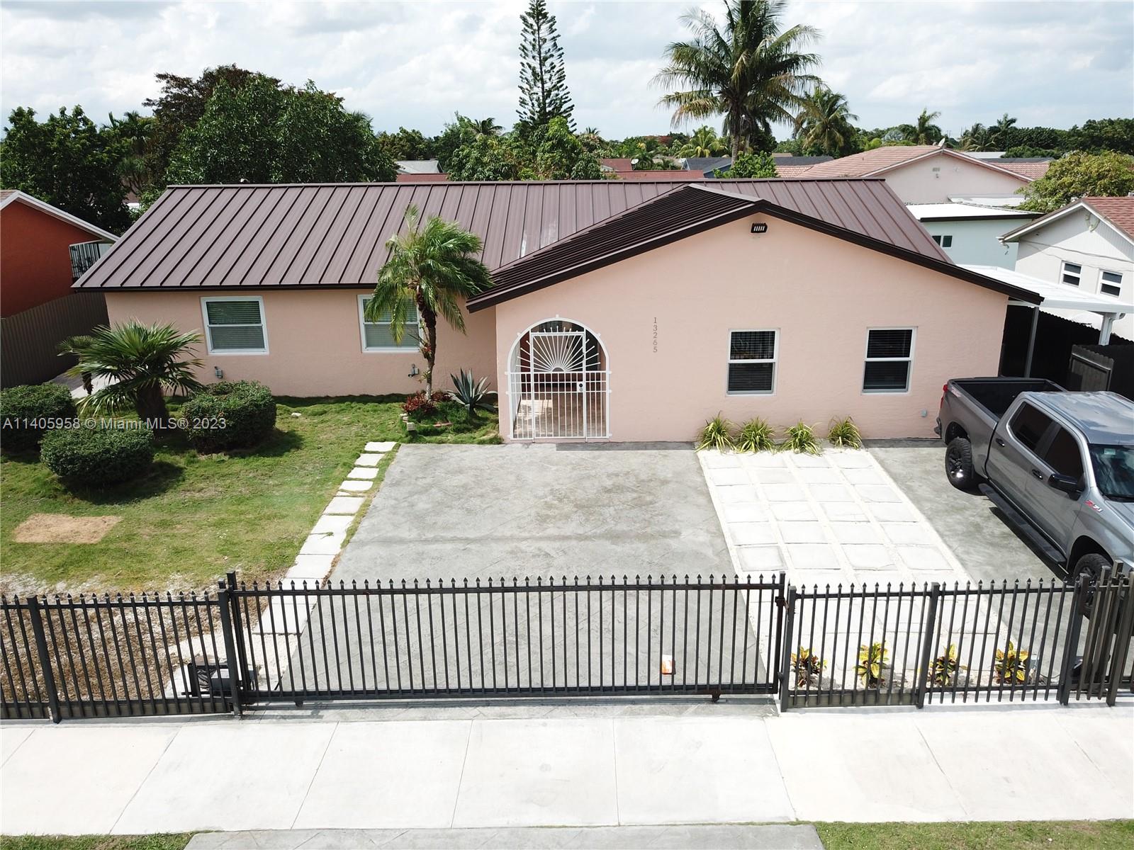 Beautiful 3-bed 2 -bath home with added 1-bed and 1-bath in-law quarter. Completely renovated with all new appliances, impact windows, metal roof, concrete driveway, automatic gates, and paver throughout. A covered back porch opens up to a backyard with lush fruit trees and lovely patio area. Don't miss this incredible opportunity!