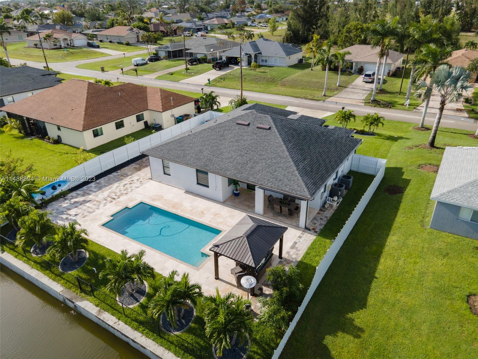 Built in 2021, this exceptional residence offers 3 bedrooms plus Den/Office and 2 baths. Hurricane season ready with impact windows and doors! This home has been completely upgraded with high end quality and cafe brand stainless steel kitchen appliances. Retreat to the luxury of the master bathroom, including a shower and jacuzzi. Outdoor paradise with salt water system and heated swimming pool, fresh water canal with a secure seawall and breathtaking sunsets right from your backyard. City water and sewer, with assessments paid. Also ideal for short-term rentals.