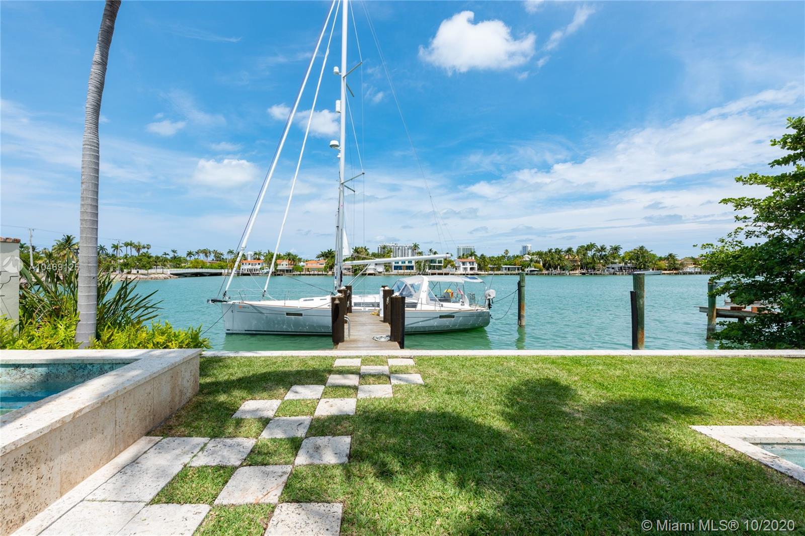 Beautiful Mediterranean-style waterfront on the Venetian Islands in Miami Beach. Detailed with arched doorways, high ceilings, wood-burning fireplace, and large windows among many other are the glass-enclosed living room with a built-in entertainment bar, the family room, and the formal dining. The first floor is completed with an office with a powder room, a staff room, and an eat-in kitchen with a breakfast bar. Four bedrooms upstairs, including a master suite with 2 walk-in closets and beautifully renovated mosaic tile bath. Step outside to find yourself surrounded with lush vegetation, the scent of blossoming flowers, and a sight of the water. The backyard features a large pool, a spa, full cabana bath, a gazebo with a summer kitchen, and an observation deck.