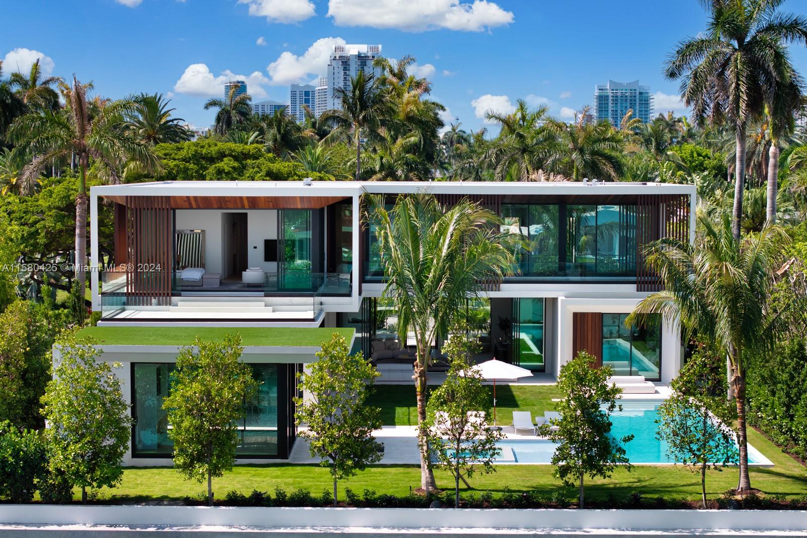 This new construction modern masterpiece sits on a 20,000 SF lot with 100' of water frontage on ultra exclusive and serene Sunset Island II. No detail was overlooked in this home that boasts 7 bedrooms and 9 and a half bathrooms. The great room, flanked on one side by a full sized marble wet bar is an entertainer's dream. A large home office can be used as a separate, private family room or theatre. Two full kitchens allows for your chef to cook while you entertain. The primary bedroom contains 2 bathrooms and 2 closets. As you step outside, the separate gym/spa structure has a hybrid sauna and steam shower. In front of the gym a cold plunge sits just in front of your 50' pool with jacuzzi. Bring your 90' boat to the L-shaped dock and enjoy the Miami lifestyle to its fullest.