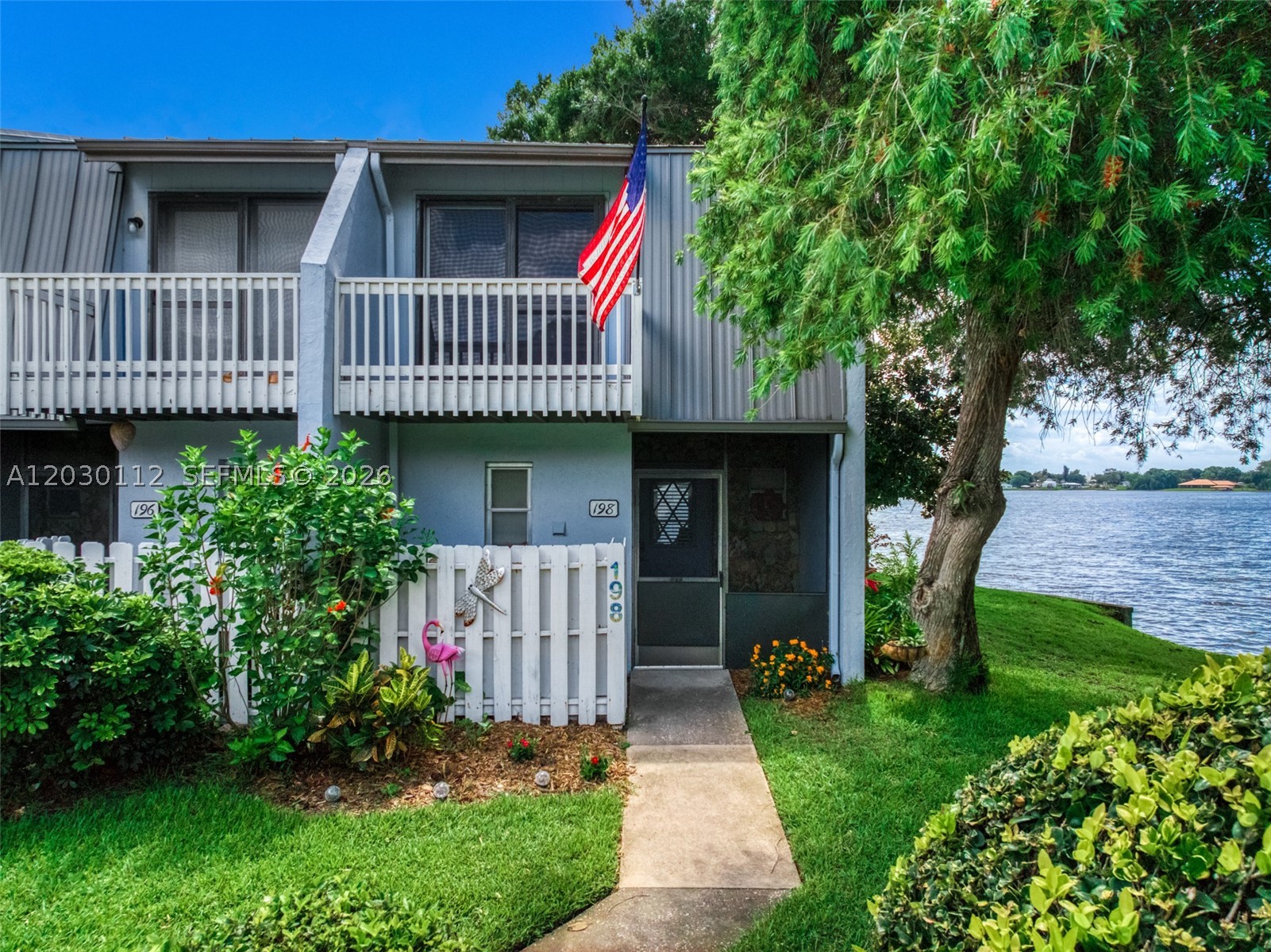Rare opportunity to own your own townhouse villa directly on the lake. This villa is one of only 12 units in the community. Tucked away at the end of a quiet cul de sac. This is a corner unit with views  through to the lake outside. The main level  is spacious featuring the living dining area, breakfast bar and a kitchen with a walk in pantry. With a lanai in both the front and back of the house for additional entertaining. There are two master bedrooms upstairs with private lanais as well. Great to have morning coffee and enjoy a sunrise or to watch the sunset with friends at the end of the day.  The house is well arranged with numerous updates including new bathrooms, screens, stainless steel appliances, and kitchen counters.  You have your own personal boat dock with new motor for the lift. Bring your boat and you will be out on the lake in no time. Your villa comes with a personal outdoor storage shed to store all those extra toys for fun on the lake. The community has exceptional amenities including a covered lakeside patio with a gazebo, grilling area, a fishing dock and a sandy beach to relax with a book. Residents also enjoy all the amenities of the Sun n Lakes community center. Including a separate boat launch, pickle ball courts, a park and lots of social activities. The villa is located a short drive to the charming Lake Placid downtown area where there are restaurants and shops. This lakeside retreat could be yours.  Call for a private showing before it is gone.