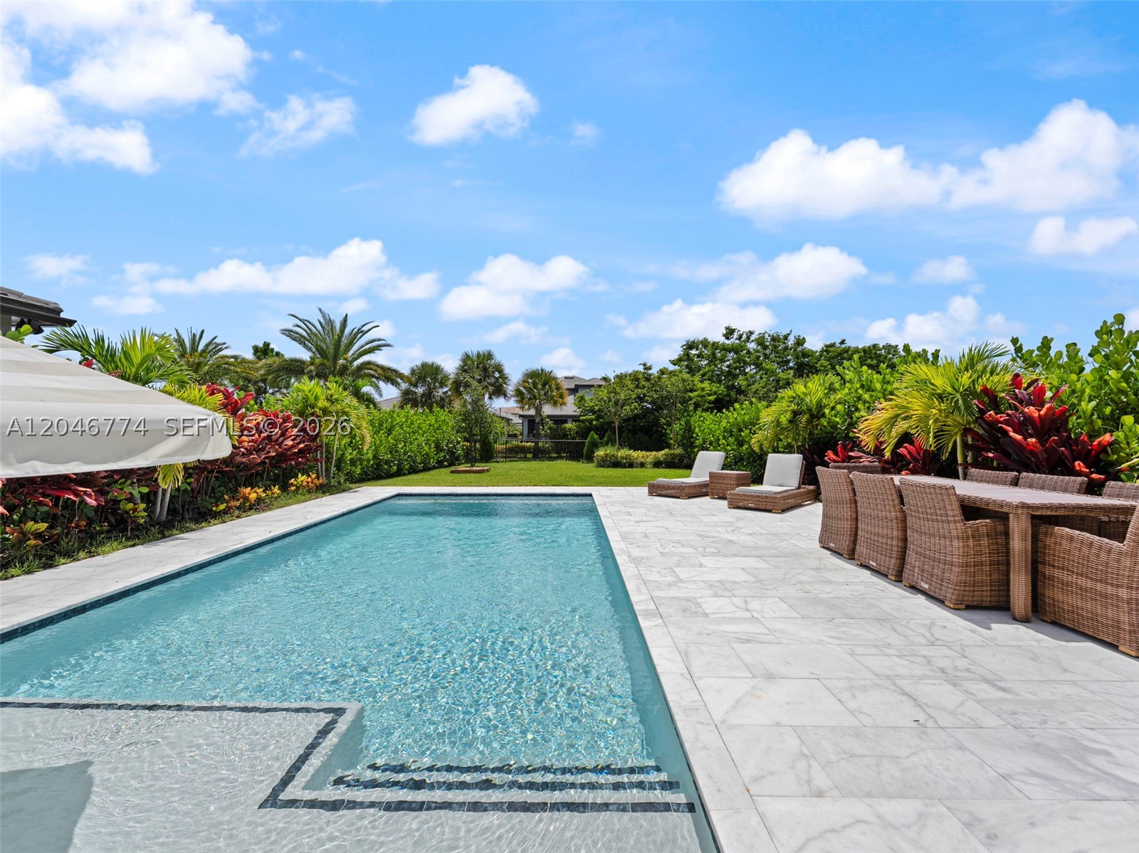 2023 Build | 3 Bed + Den/Office | 2.5 Bath | Resort-Style Pool | Cul-de-Sac. Luxury meets lifestyle in this beautifully upgraded, move-in ready home in the exclusive gated Oak Tree community. Perfectly situated on a quiet cul-de-sac, this exceptional residence offers all the benefits of new construction without the wait or added expense. Featuring 3 spacious bedrooms, a versatile den/office/flex room, 2.5 bathrooms, and two separate living areas, it delivers the ideal blend of comfort, style, and functionality. The chef's kitchen showcases premium finishes, abundant cabinetry, a large center island, and an open-concept design that flows seamlessly into the bright living space—perfect for everyday living and entertaining. Step outside to your private backyard retreat featuring a custom heated and chilled saltwater pool with a sun shelf, expansive covered lanai, and elegant Ibiza White marble patio on a generous lot. Enjoy resort-style amenities including a gated entrance, clubhouse, pool, fitness center, pickleball courts, and scenic walking trails. This is South Florida living at its finest!