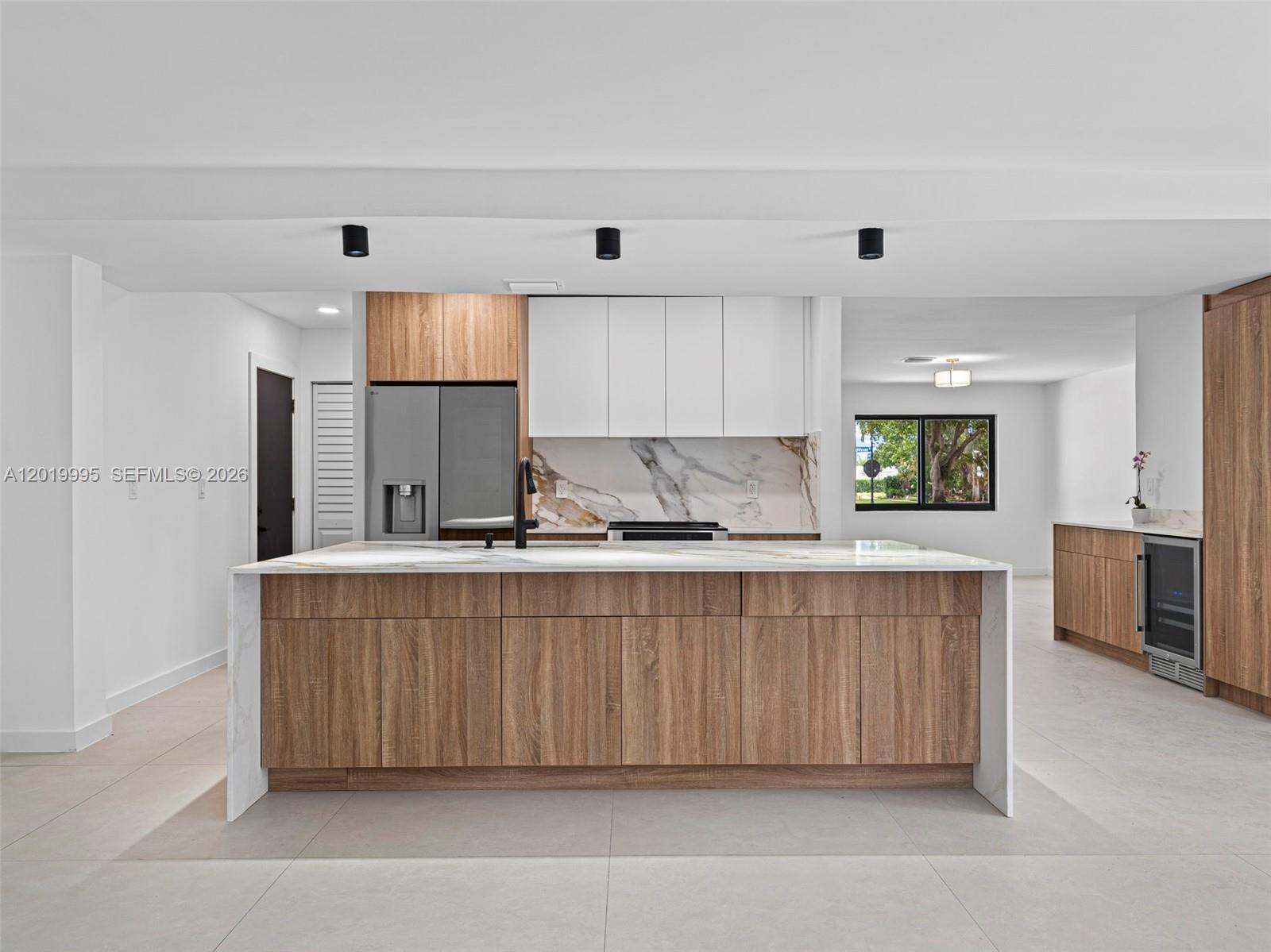 Welcome to this stunning, like-new Coastal Modern Pool residence in Village of North Palm Beach, just minutes from the water. This new construction 4BD/2BA home has been redesigned from the ground up with high-end finishes throughout. The open-concept layout showcases 40x40 two-tone porcelain tile floors and a designer European kitchen with an oversized 9 foot island in Calacatta Quartz, two-tone cabinetry, stainless steel appliances, pantry, built in microwave and bar/coffee station with a wine cooler for added convenience. The pool house extends your entertaining space beautifully. The master suite is a true oasis with French doors opening directly to the pool and a luxurious his-and-hers bathroom with upgraded porcelain large tile. The secondary bath also features quality finishes throughout. Enjoy the screened-in patio — perfect for relaxing or entertaining in style. Additional highlights include a 1-car garage with FULLY permitted garage door, all-impact windows and doors, brand-new plumbing, electrical, and mechanical systems. Circular driveway is another convenient feature. This home delivers coastal elegance, modern luxury, and total peace of mind. Close to Anchorage Park & Marinara with dog parks and boat ramps. The home is also just minutes from the North Palm Beach Country Club, offering golf, tennis, restaurants and oversized heated pool and splash pad. MUST SEE!