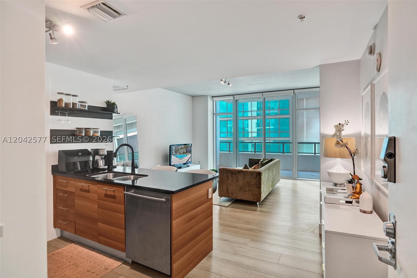 Welcome to Midtown Miami living at its finest! This beautifully upgraded 1 bedroom 1-1/2 bath residence offers a stylish blend of comfort, convenience, and modern design. Featuring over $50,000 in improvements, the home includes a newer A/C system, updated appliances, renovated bathrooms, custom built-in storage solutions, Ecobee smart thermostat, new baseboards, and luxury flooring throughout. Soaring ceilings and impact windows fill the space with natural light while providing peace of mind. The thoughtfully designed floor plan offers generous living and storage space, making it ideal for both end users and investors. Residents enjoy resort-style amenities including a heated pool, fitness center, sauna, business center, 24-hour concierge, and secure entry. Located in the heart of Midtown, you’re just steps from premier dining, shopping, cafes, fitness studios, Target, Trader Joe’s, and minutes from Wynwood, the Design District, and Downtown Miami. Pet-friendly building with assigned parking included. A fantastic opportunity to own in one of Miami’s most vibrant and walkable neighborhoods.
