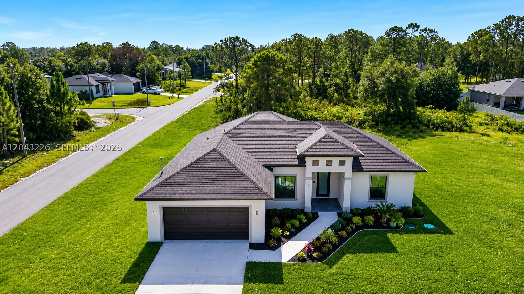 Seller offering closing cost assistance, including seller concessions/contributions toward buyer closing costs. Move-in ready new construction with Certificate of Occupancy issued and immediate occupancy available. Situated on a CORNER quarter-acre lot, the property features 4 bedrooms, 2 bathrooms, a 2-car garage, a covered lanai, and an OUTDOOR SUMMER KITCHEN—perfect for entertaining and enjoying Florida living year-round. The open-concept layout is designed for comfort and durability, highlighted by 14-foot ceilings in the foyer and 11-foot ceilings in the great room and primary suite, creating a spacious feel. Interior finishes exceed standard builder-grade specifications and include porcelain tile flooring throughout, impact-rated windows and doors, a cohesive interior design package, and smart mirrors in the bathrooms. The kitchen features quartz countertops with a full-height matching quartz backsplash, upgraded wood cabinetry, a dedicated pantry, a large center island, stainless steel appliances, and a smart refrigerator. Additional features include a spacious primary suite with a walk-in closet, a laundry room with utility sink, and a professionally finished epoxy garage floor. Conveniently located with easy access to I-75, Fort Myers, Southwest Florida International Airport, shopping, dining, and schools. Easy to show.