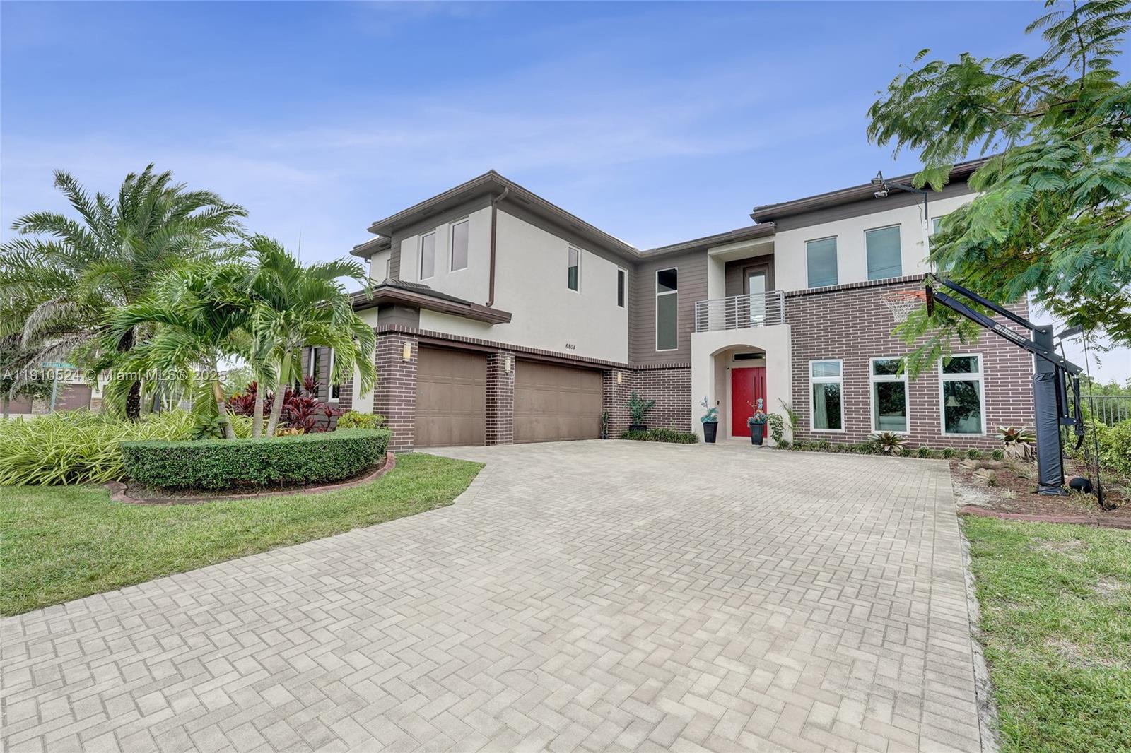 Discover lakeside luxury in Davie’s most exclusive gated enclave—limited to just 20 homes. This 5-bedroom, 4 bath corner-lot estate offers serene lake views and timeless sophistication with marble flooring, Monogram appliances, and a custom theater room. The spacious master suite occupies the upper level for ultimate privacy, while a saltwater pool and three-car garage complete this refined retreat. Offered furnished or unfurnished, this residence blends elegance, comfort, and convenience in a prime location just minutes from the Hard Rock Casino and Miami Dolphins Hard Rock Stadium.
