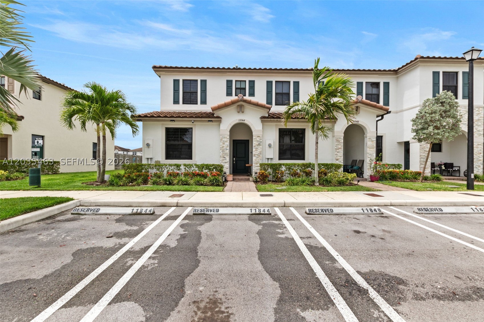 Beautiful Townhouse in a corner lot with 3 Bedrooms and 3 Full Bathrooms. One Bedroom with a bathroom is conveniently located downstairs.  All tastefully updated, with new porcelain tile on the 1st floor and vinyl flooring on stairway and 2nd floor hall. Modern outdoor lighting, and comfortable covered patio ideal for outdoor entertainment. Impact windows and doors. Two assigned parking spaces. Low HOA. Enjoy the community amenities, including clubhouse, exercise room, 24-hr security, and swimming pool. Excellent location, close to dining, shopping, and Turnpike.