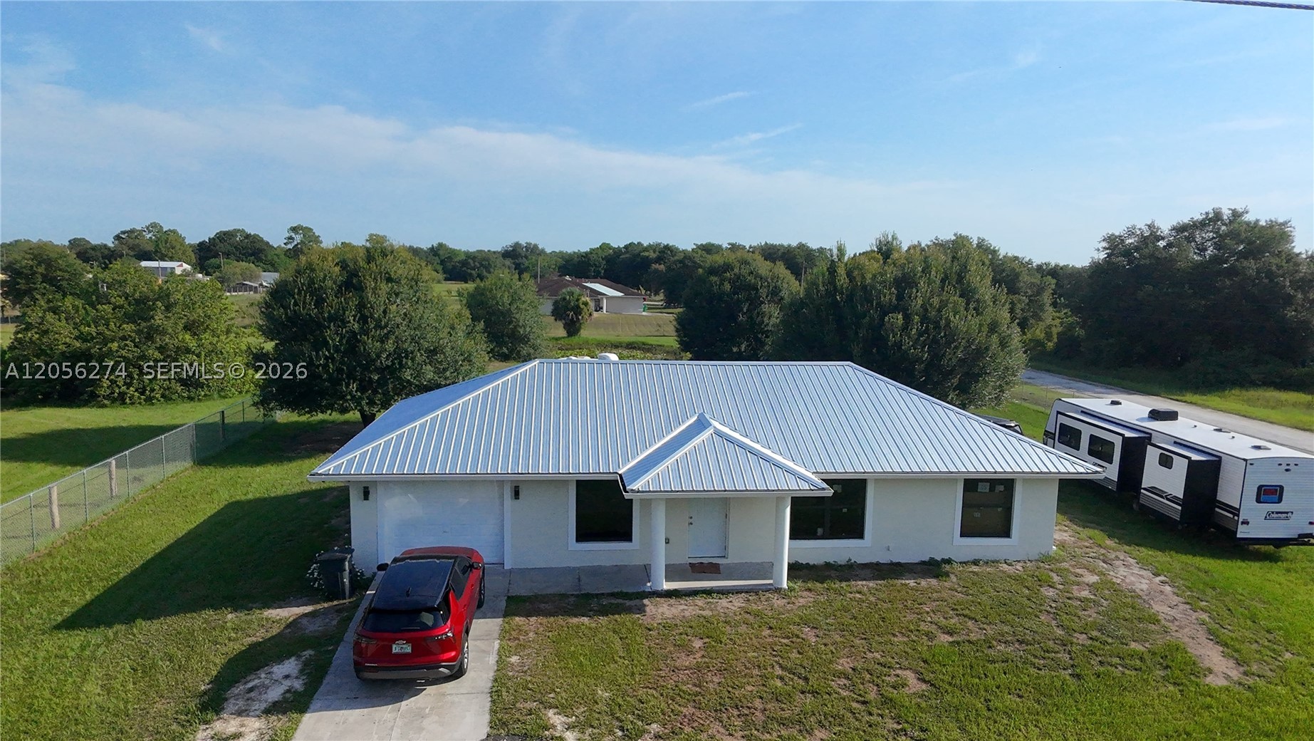 Welcome to 369 Horse Club Ave in Montura Ranch Estates! This beautiful 3-bedroom, 2-bath home sits on a spacious 1.25-acre lot, offering the perfect blend of privacy and country living. The open-concept floor plan features a modern kitchen with quartz countertops, stainless steel appliances, and a bright living area. The primary suite includes a walk-in closet and a private bath. New 2025 METAL ROOF, impact windows and fence all-around the property. Plenty of room for horses, RVs, boats, or future additions. Enjoy peaceful rural living while still being within driving distance of Clewiston, LaBelle, and South Florida. No HOA. Schedule your private showing today!