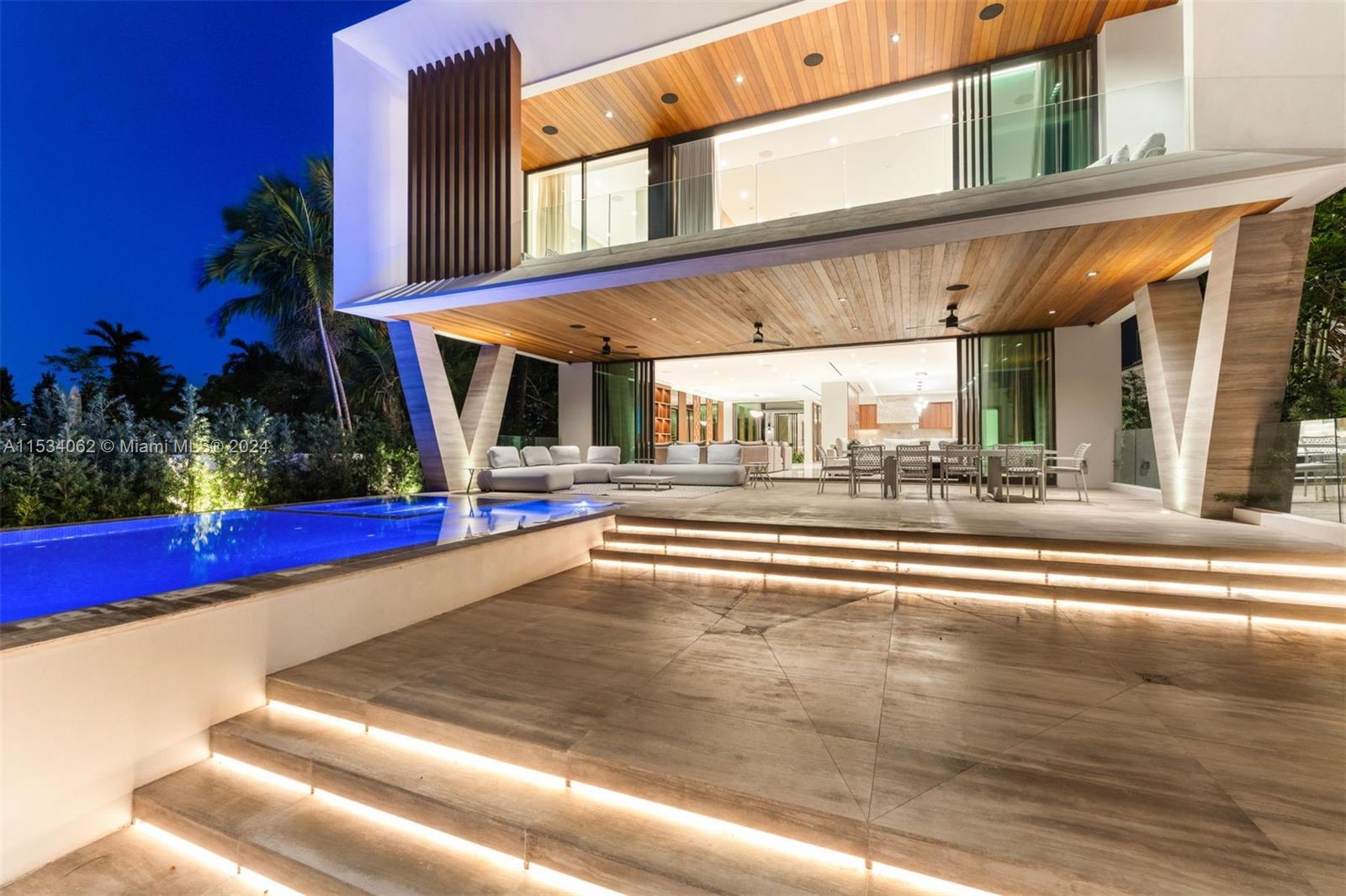 Discover an unrivaled masterpiece of modern tropical design in prestigious Surfside. Brand new 2023 construction features 7 BD/9.5 BA, 10,799 total SF w/60’ WF on 15,029 sf lot. Best unobstructed waterfront views on the street. From the captivating 25-ft waterfall at the entrance to the grand double-height ceiling foyer, every aspect exudes sophistication. Luxurious features: waterfront terraces, marble walls in principle bath, stone/wood flooring, generator & insulated impact glass. Enjoy premium amenities:sauna, spa, home theatre, office. Outside a large pool & outdoor kitchen offer endless sunset views. Complete w/ Crestron smart home system, security cameras, elevator, speakers, this home defines luxury living. Moments from Bal Harbor shops, the beach, the Surf Club & houses of worship