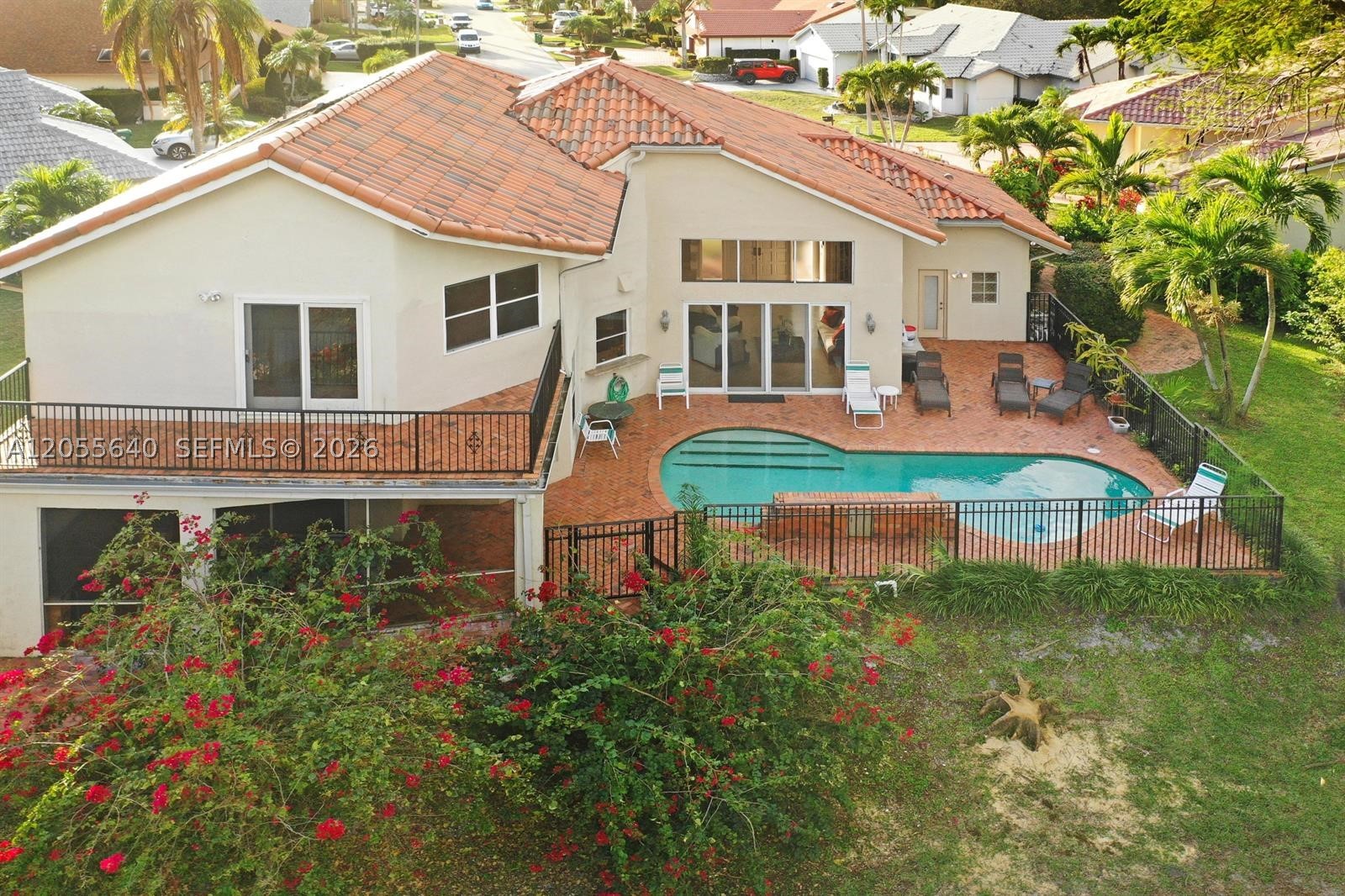 Wake up to golf-course views every single day. Tucked into a quiet cul-de-sac in Tamarac, this 3,000+ sq ft Mediterranean-style 2-story sits on a sprawling 10,000+ sq ft lot, and there's NO HOA to slow you down.
Inside, cathedral ceilings soar over travertine and wood flooring, leading you through a split floor plan with 4 spacious bedrooms, 3.5 baths, plus an additional room/office with its own closet and ensuite cabana bath that opens straight onto the pavered pool deck. The chef's kitchen brings state-of-the-art appliances, a gas range, walk-in pantry, and custom solid wood cabinetry, built for real cooking, not just show.
Step outside to your private resort: a brick-paved pool with a fountain waterfall, a covered lounge with outdoor kitchen, and a lushly landscaped, fully fenced backyard framed by unobstructed golf-course views. Upstairs, the primary suite delivers a private balcony overlooking it all, plus a spa-style bath with a soaking tub, custom walk-in shower, and generous closets.
Add a full 2-car garage, laundry room with front-load washer/dryer, and thoughtful upgrades throughout, this is a home built for both everyday living and standout entertaining.
Homes like this don't sit long. Call today before someone else calls it home.