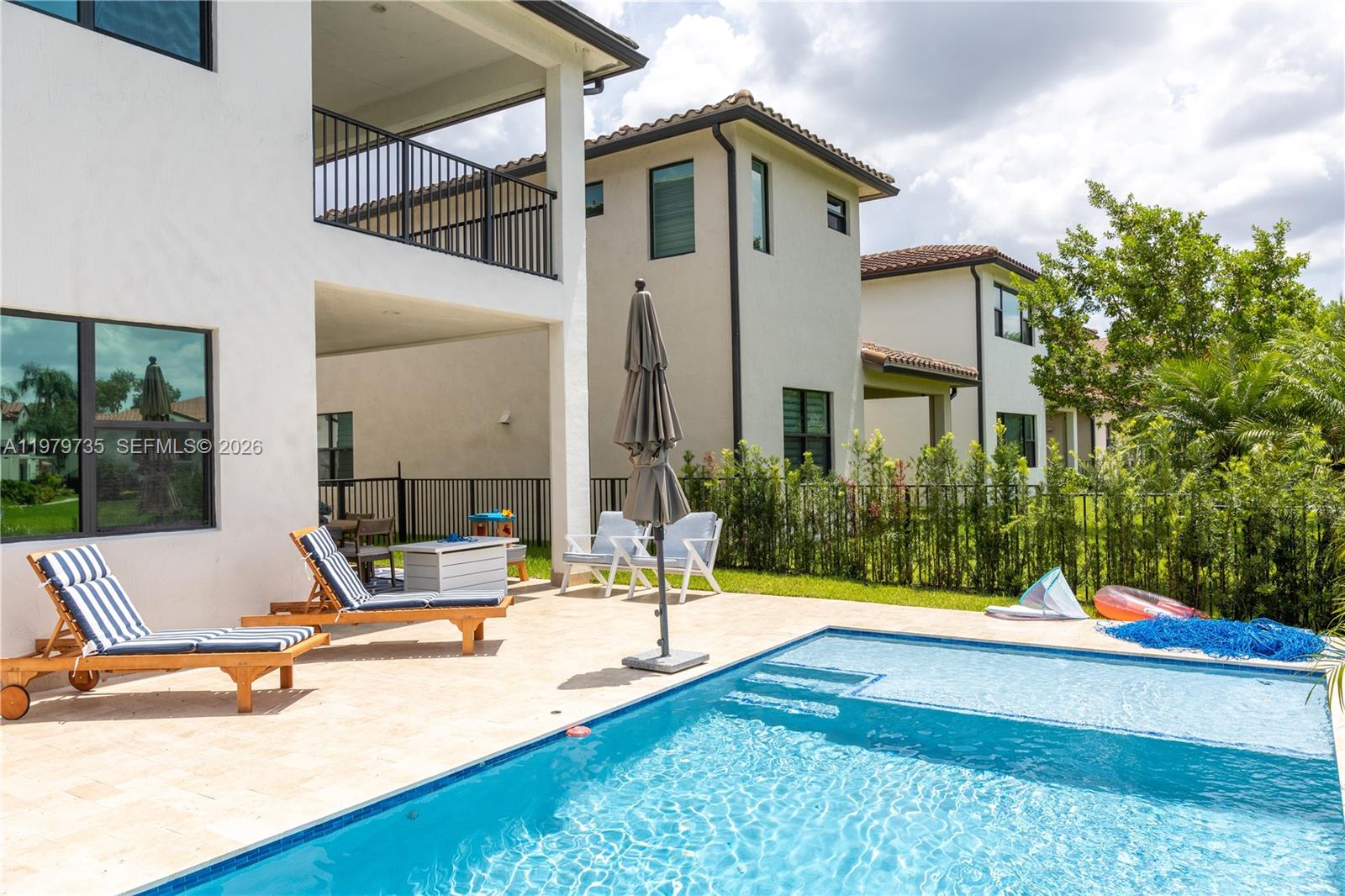 “Exquisite residence located in the prestigious gated community of Raintree in Pembroke Pines. This elegant home offers 4 bedrooms and 3 full bathrooms, including a conveniently located first-floor bedroom with en-suite bath—ideal for guests or multigenerational living. Designed with a refined open-concept layout, the home features expansive living and dining areas filled with natural light and enhanced by serene canal views. The outdoor space is a private retreat, showcasing a beautifully appointed patio, along with a newly constructed pool area and terrace, thoughtfully designed for family enjoyment, comfort, and relaxation, offering a beautiful ambiance and lovely views. The pool features a saltwater system and is equipped with a remote-controlled operation system for added convenience. It also includes elegant deck jets, enhancing both the visual appeal and overall outdoor experience. Raintree is a secure and highly sought-after community, providing privacy, tranquility, and a prime location close to top-rated schools, shopping, and dining.”