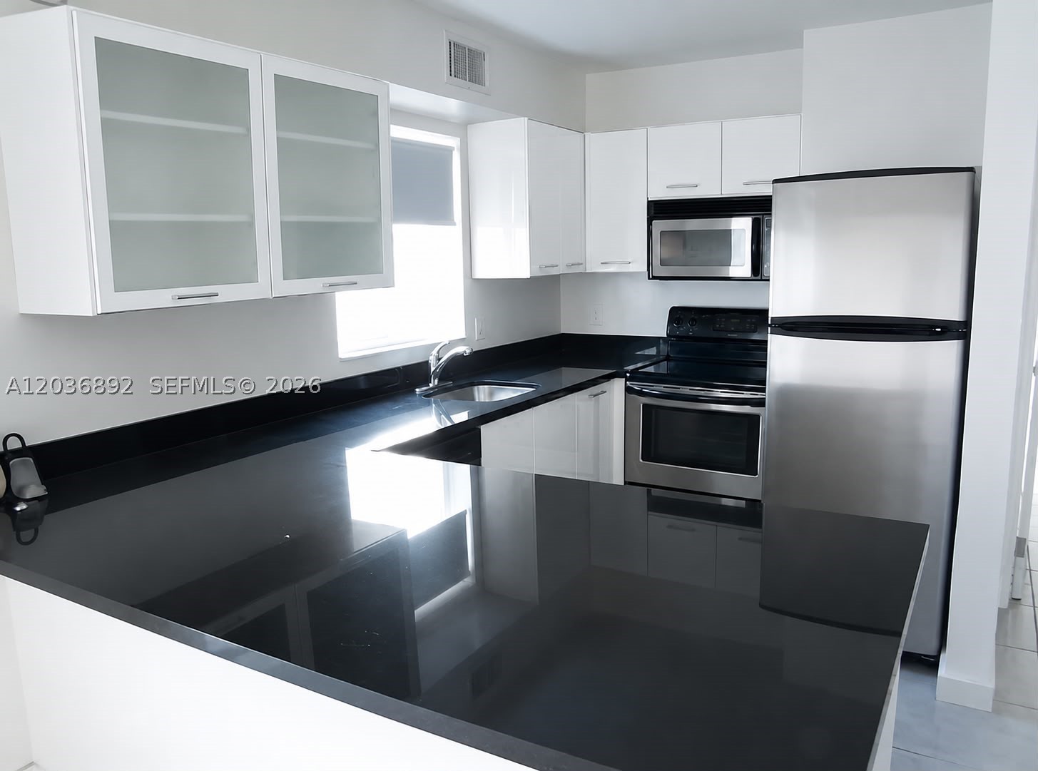 Water view from bedroom. Renovated corner unit with tile floors and granite counter top in the kitchen. Gated community with 24 hour security. Minutes from Downtown, Midtown, and Miami Beach. Jacuzzi, volleyball, fitness center, and two pools on property. Washers and dryers are on the first floor of the building. No washer or dryer in the unit. Kitchen cabinets will not have 2 glass doors or handles. Pet friendly community. Guest parking available. There is a $500 refundable deposit that goes directly to the HOA. One time parking pass fee and gym fee to be paid directly to the HOA ($25-$50). Please submit credit report, rental references, and proof of income with contract to lease.