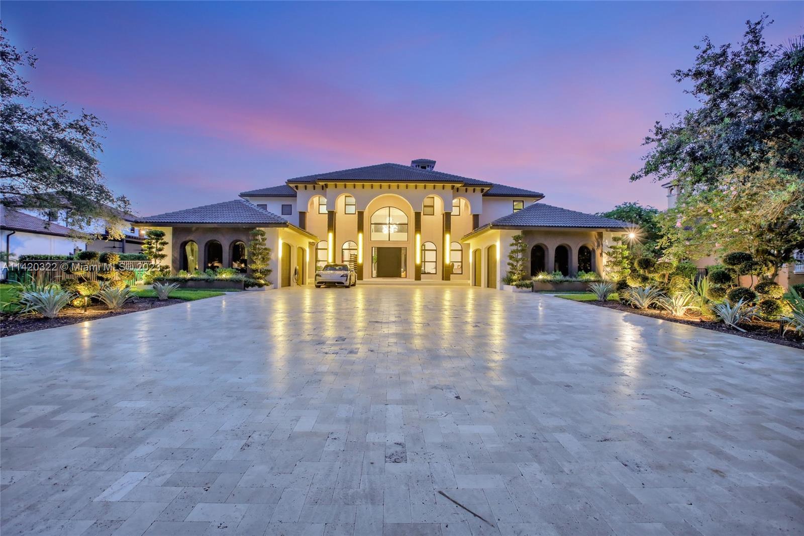 One of a kind masterpiece fully remodeled with top quality finishes & No expense spared. Majestic entrance with luxury pivot door, high 24' ceilings, floating stairs & bright backyard views. Home features 8 beds, 9.5 baths + office & a state-of-the-art theatre room. Modern LED baseboards, Surround system & Impact windows/doors throughout. Kitchen is every chef’s dream including exotic Taj Mahal quartzite countertops, gas stove, wine cooler & top-of-the-line Dacor/Miele appliances. Designer handcrafted stone wall for wine collectors. Tropical paradise backyard fully equipped for the perfect entertainer featuring a 70’x30’ pool with swim up bar/infinity edge waterfall, custom summer kitchen, pergola, sunken seating area, & green space for outdoor activities. 4 car garage & oversized driveway