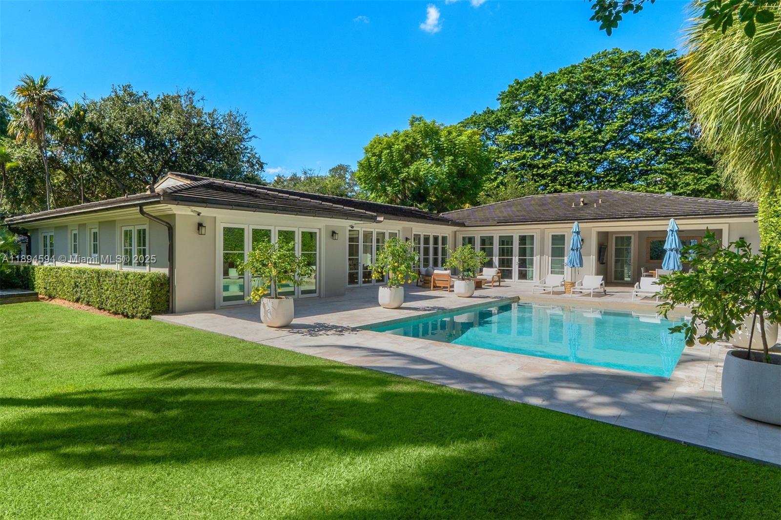 Rebuilt in 2019, this 5BD/5.5BA turn-key home located in prestigious, guard-gated Bay Point Estates, blends timeless charm with modern luxury. Approx. 4,000SF under AC on a corner 16,613SF lot. Wood flooring throughout exudes warmth and tranquility with the finest attention to detail. The floor plan optimizes  living and entertainment space with a state-of-the-art chef’s kitchen, dining room with adjacent wet bar and family-style den, all with direct access to the pristine backyard. A salt water heated pool, covered patio, and built-in BBQ surrounded by lush landscaping provide ultimate privacy and pleasure. Addl. features include whole-house generator, Sonos sound system and water filtration system. The epitome of refined living, exceptional design with a true sense of exclusivity.