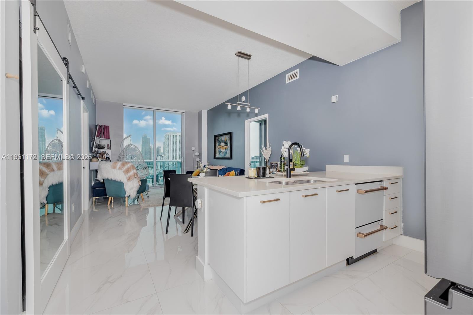 Modern living meets city energy in this beautifully remodeled 2/2 + Den condo in sought-after Edgewater. This smart home features a bright open floor plan, tasteful contemporary finishes, private balcony, stunning city views. This residence offers the perfect blend of comfort and sophistication. Enjoy resort style amenities including a gym, pool and hot tub. All just moments from Midtown, Wynwood, Design District and Downtown Miami. Ideal as a primary residence or investment property.