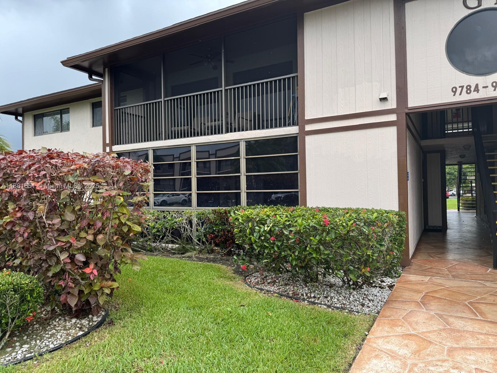 A MUST SEE!!! Well-Maintained and sought-after 55+ Community of Belfort, Kingspoint - in the heart of Tamarac. This spacious second floor condo offers 2 bedrooms / 2 bathrooms, featuring updated wood cabinetry and granite countertops in the kitchen. Enjoy the comforts of the all tiled and screened-in patio, perfect for morning coffee or evening breezes. Home also includes an in-unit full size washer and dryer with abundant storage space for convenience. Comfortable living in a quiet and friendly community that features; resort-style clubhouse, olympic sized pools, heated pools, fitness center, sauna, theatre, tennis and pickleball courts, bus services and many more club activities. Located close to Sawgrass Expressway, Tamarac Sportsplex, and easy access to shopping and dining.