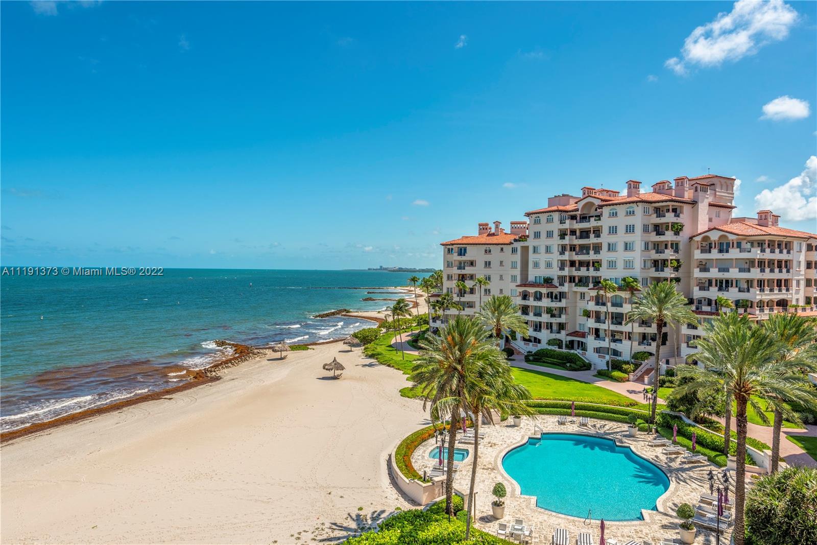 Experience Fisher Island living at its finest in this exquisite 5th Floor Oceanside corner-unit in one of the newest and best-maintained buildings on the island. Walk up to the impeccable courtyard or peruse the sandy mile-long beach steps away overlooking the Atlantic Ocean skyline. Renovated unit with the finest finishes, the unit showcases 3 Bed/3.5 Baths w/ large porcelain floors throughout, Venetian Plaster finishes, a large open kitchen with Meile, Sub Zero, & Gaggenau appliances w/ granite countertops and island, impact glass doors that lead to your wrap-around balcony, & terrace that overlooks the unobstructed serene skyline and an additional terrace off your guest bedrooms that overlook the city, golf course & ocean views. 2 assigned garaged parking, golf cart, and large storage!