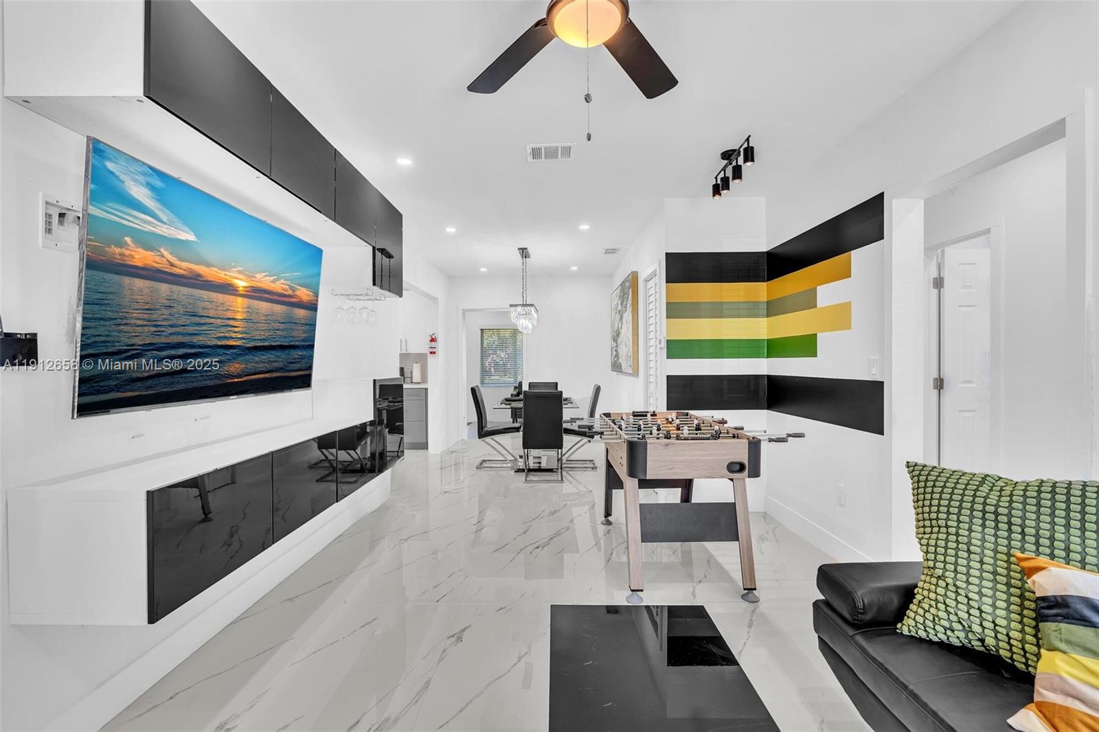Stunning Fully Renovated 4-Bedroom, 2-Bath Home Near Wynwood & designer district! This spacious home features a 2019 roof, impact windows and doors, and 2025 upgrades to electrical, plumbing, and tankless water heater. elegant porcelain tile flooring, recessed lighting, and a modern layout. kitchen boasts all-new cabinets, Quartz countertops, and premium stainless steel appliances. Both bathrooms fully remodeled, offering stylish finishes. Enjoy a bright family room and dining area. freshly painted inside and out, the home sits on a generous lot with a lush backyard, perfect for relaxing or entertaining.