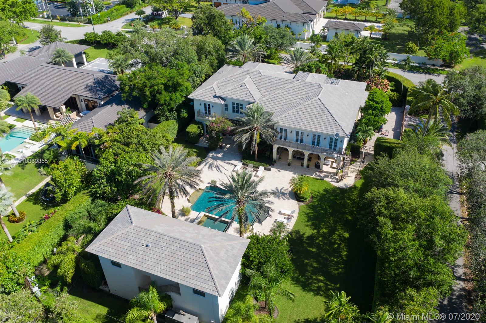 Splendid Ponce-Davis ESTATE has it all: Timeless, transcendent architecture; gated builder’s-acre corner lot; enchanting, resort-style setting. Old Florida meets Modern Miami in the trend-defying, grandly scaled 9,474SF Smart Home distinguished by stately, classic lines, soaring entry & exquisite craftsmanship. Features: Elevator, impact windows/doors, high ceilings, marble floors, masterful woodwork. Heart-of-the-home Kitchen, Breakfast rm, formal Living & Dining rms; Family rm w/XL Bar & Wine Cellar; Game & Media rms. Breathtaking Master w/Office, His&Hers closet, luxe Bath w/2 WCs; expansive en-suite Bdrms; Laundry rm, 3-car Garage. Covered outdoor kitchen, Pool w/Spa, mature Landscape. +1,710SF Guest House! Prime location near shops, dining, schools & parks. Ponce-Davis paradise found!