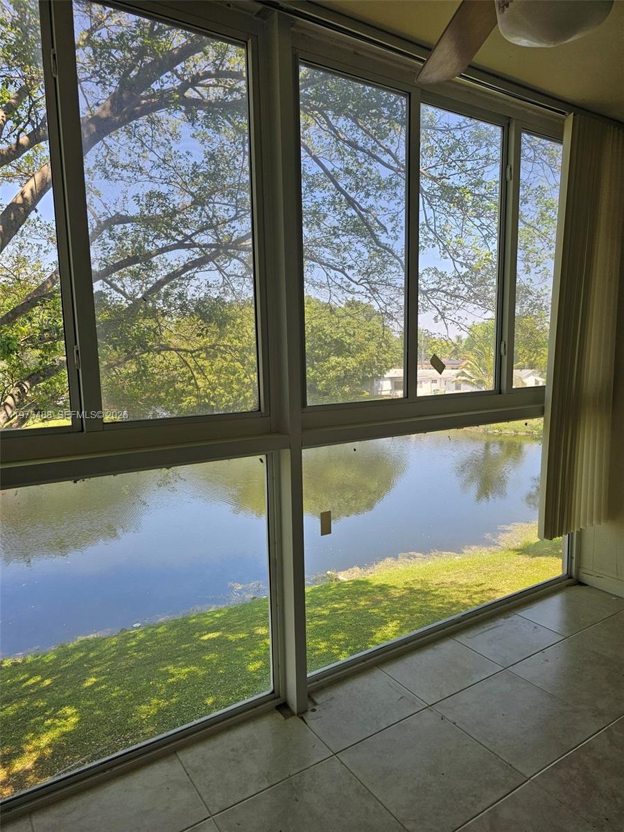 Take in the breathtaking Lake view as you enter this Modernized 2/2 55+ Condo on 3rd floor. Move in ready to enjoy the tranquil lake view from living room, primary & balcony. Eat in kitchen, new stove, newly remodeled baths, new water heater, 2024 AC, glassed in balcony/sunroom to relax enjoying stunning sunsets. Tile floors, newly carpeted bedrooms, impact windows, LOW $529 per month maintenance. Well maintained building, management company. Laundry facilities & storage on floor, tennis, shuffleboard, pool, gym, community room, BBQ, picnic area, trash chute, 1 assigned parking spot, international neighbors, close to shopping.