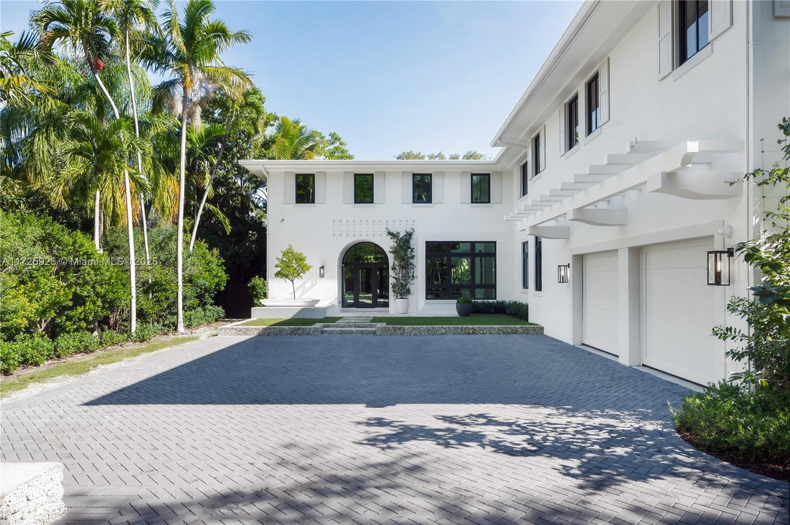 Nestled within exclusive South Coconut Grove behind a gated private lane on Park Ave, this gem epitomizes luxury. Crafted by renowned architect Jorge L. Hernandez, the estate features 5 beds, 4 baths, & 2 half baths. Experience quiet luxury with lush tropical surroundings, expansive living spaces seamlessly blending indoor and outdoor living. Enjoy the comforts of a summer kitchen, lap pool, two-car garage, and ample outdoor areas. Classic Grove architecture shines through open, light-filled rooms, whitewashed walls, pergolas, and a historic coral stone wall weaving amidst native trees. Less than a mile to top-tier schools, dining, shopping, and entertainment in Downtown Coconut Grove from this exceptional property.