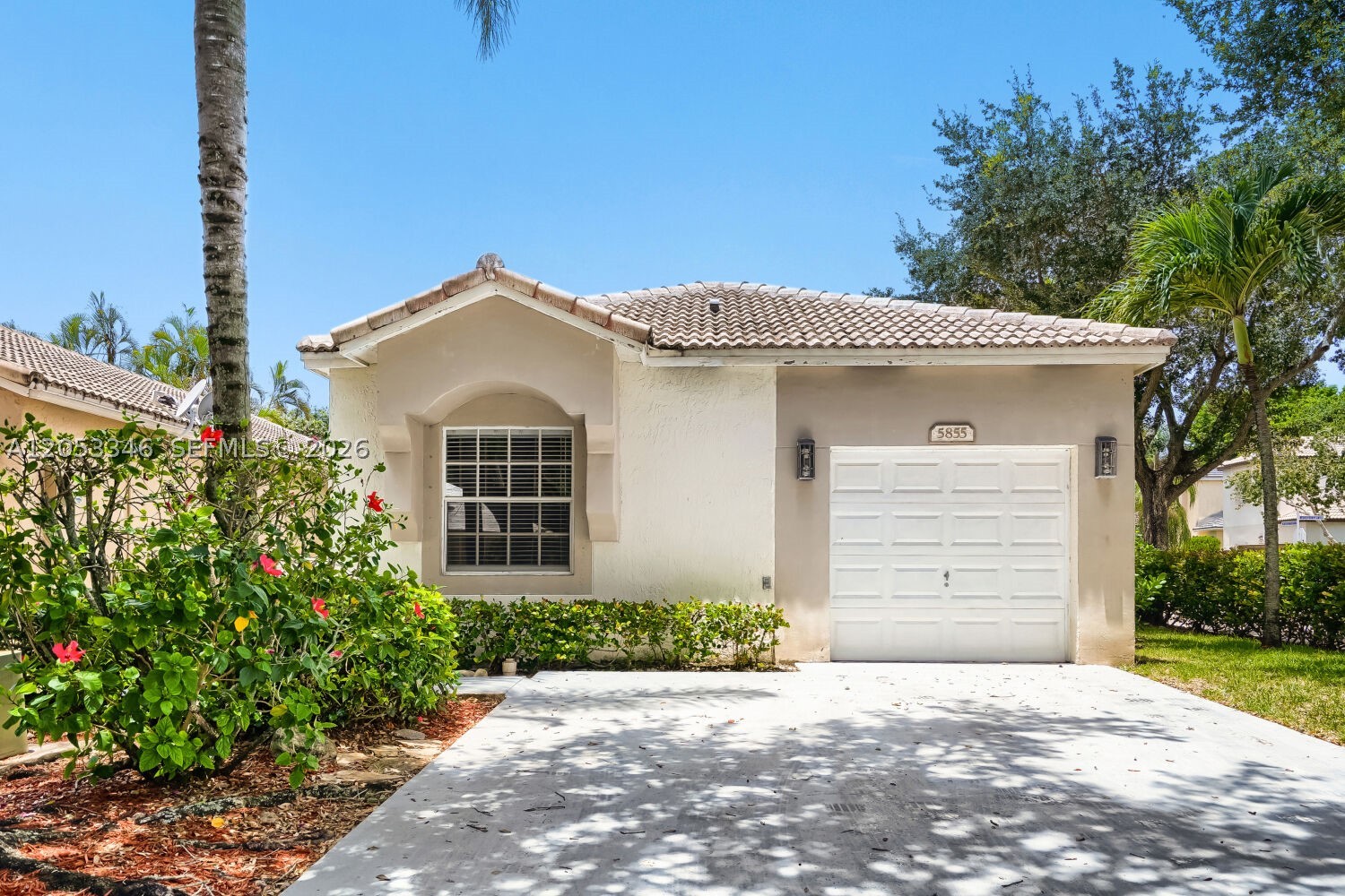 Gorgeous single-story home nestled in the premier, guard-gated community of Regency Lakes in Coconut Creek! This immaculate 3-bedroom, 2-bathroom single-family residence welcomes you with a bright, open-concept floor plan beautifully accented by sleek luxury vinyl plank and tile flooring. The heart of the home features a breathtaking kitchen fully loaded with premium granite countertops, stainless steel appliances, custom cabinets, and a versatile breakfast bar tailored for effortless daily living. Retreat to the spacious primary suite, conveniently located on the main level and boasting a generous walk-in closet. Step outside to your private, fully fenced backyard featuring an attractive patio space perfect for soaking up the South Florida sunlight or outdoor dining. Notable highlights include a finished attached garage, a separate laundry room with a washer and dryer, and modern smart-home capabilities. Residents enjoy exceptional resort-style neighborhood amenities, including a magnificent clubhouse, a sparkling community pool and spa, a playground, and pristine basketball and tennis courts. Unbeatable Broward County location within walking distance to highly rated schools like Tradewinds Elementary and Lyons Creek Middle, with quick access to local parks, premium shopping, dining, and major commuter routes.