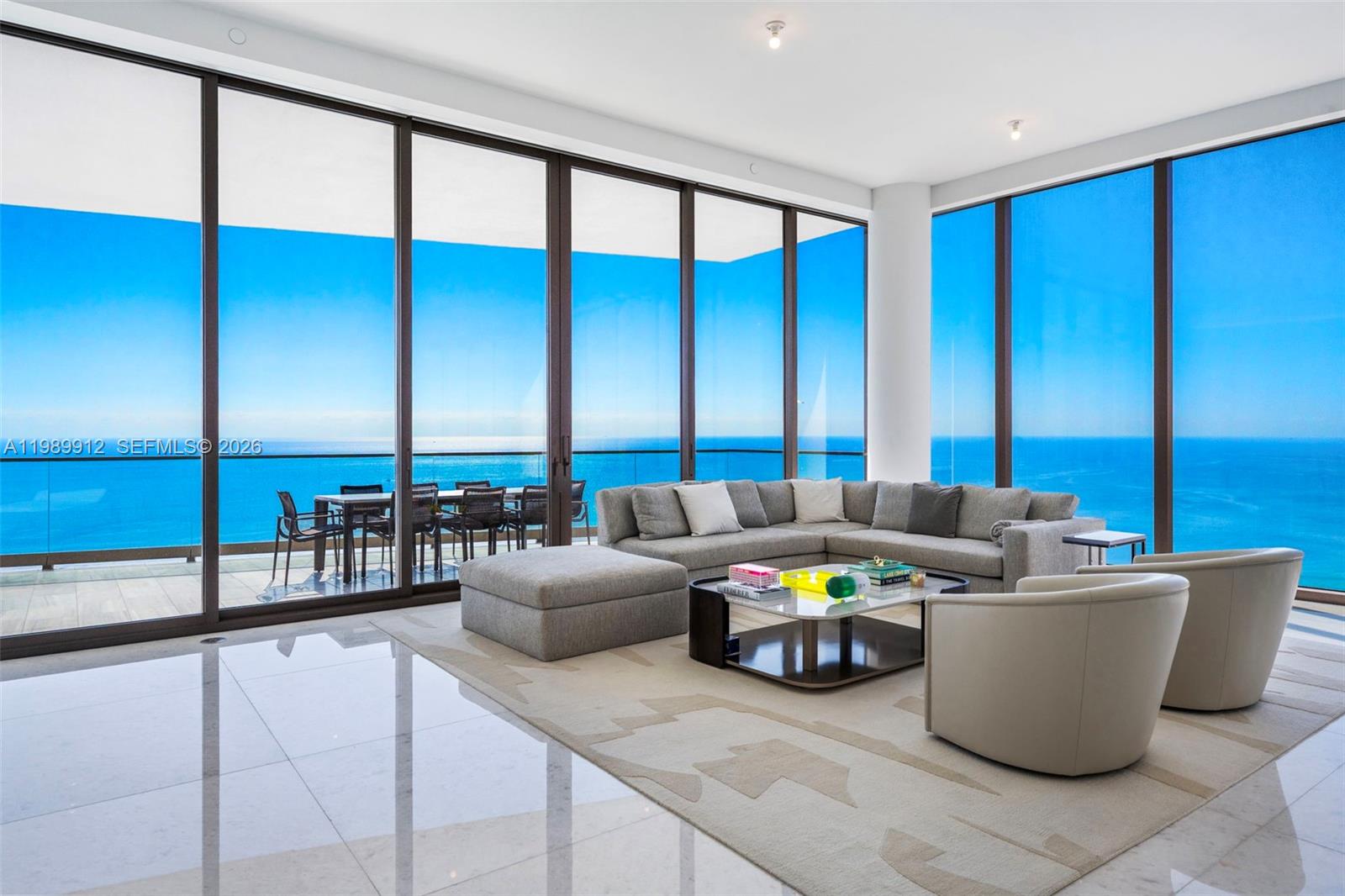 Discover the most coveted residence within "The World's Finest Residences", The Estates at Acqualina. Perched on the 45th floor, this rare south-corner trophy home is defined by soaring 12-foot vaulted ceilings—a unique architectural feature that amplifies its grand proportions. The views are boundless, stretching across the turquoise Atlantic to the glittering Miami skyline. Designed for both intimate family life and large-scale entertaining, the expansive layout includes a majestic great room and a separate family room. The residence offers four bedrooms with the flexibility for a fifth. The chef's kitchen is a masterpiece, anchored by dual La Cornue gas ranges and a full suite of Sub-Zero and Miele appliances. Throughout the home, the finishes are peerless: rare white onyx wraps every bathroom, complemented by Dornbracht fixtures and Toto washlets. Over 1,100 square feet of private terraces complete with an oceanfront sauna. Full smart-home automation for lighting, climate, audio-visual, and window treatments. Enjoy a lifestyle of unparalleled service. Five-star amenities include a private Rolls Royce fleet, five signature restaurants—including Estiatorio Avra, Il Mulino, and KeUh—and three distinct pools featuring a FlowRider and waterslide. From the ice-skating rink and bowling alleys to the F1 and golf simulators, every desire is anticipated by a dedicated concierge team.