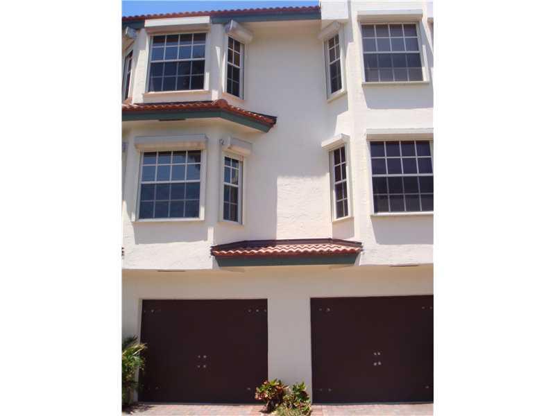 Gorgeous 3 bed/3.5 bath town home on the intercoastal with boat dock and ocean access. Totally updated with wood floors throughout and carpet in the upstairs master and second bedroom. Master has incredible view of the intercoastal and Roman tub. One car  garage plus 2 spaces.  Community pool and the beach is right across the street! Small and quiet gated community. Best price in the best location!