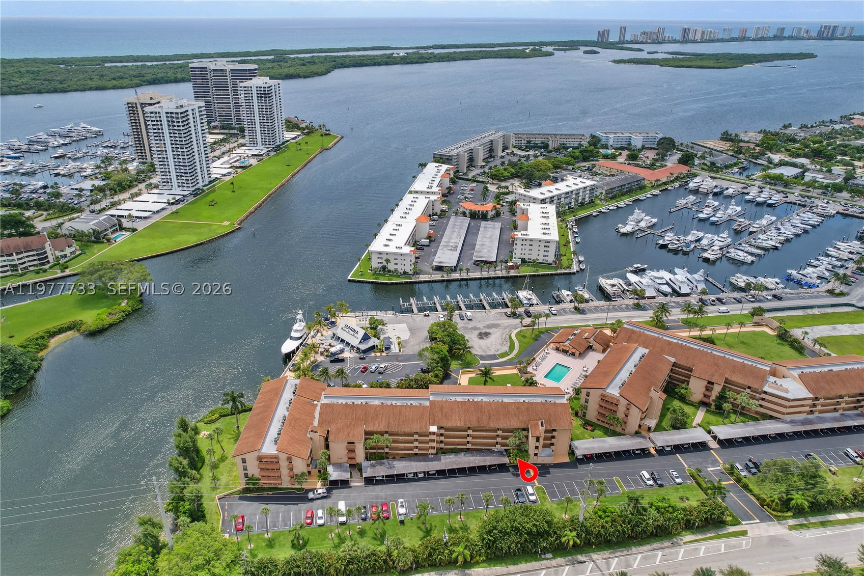 Unbeatable waterfront value! Directly across from the North Palm Beach Country Club and steps from the Marina, this updated first-floor 2/2 features new vinyl plank flooring, fresh paint and updated kitchen & baths. Start your mornings with peaceful coastal views as you stroll along the docks and sink into an effortless, beachy South Florida rhythm just minutes from premier dining, local shops, parks and pristine beaches. Features a screened patio, easy pool/pet access (20lb max) and covered parking. INCREDIBLE VALUE & PEACE OF MIND: Priced for an immediate sale! Enjoy ultimate predictability with all structural milestones cleared and the current assessment paid in full by the seller. Dues conveniently cover fast fiber-optic Wi-Fi & cable. The lowest-priced 2/2 in NPB—move-in ready and priced to move fast! Bring all offers.