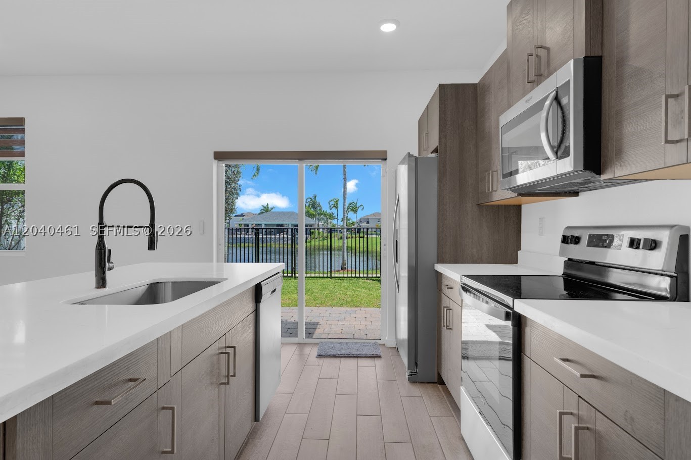 This is the one! Located in the sought-after Marbella community, this newer construction townhome offers a comfortable blend of modern living and lake views. Built in 2022, the residence features 3 bedrooms, 2.5 bathrooms, and a thoughtfully designed layout with over 1,600 square feet of living space and a large 1 car garage that offers extra space for flex use. Laundry room on the second floor! 
The heart of the home is the contemporary kitchen, complete with granite countertops, stainless steel appliances, abundant cabinet storage, and a spacious breakfast bar that opens to the main living and dining areas. Whether hosting guests or enjoying a quiet evening at home, the open-concept design provides flexibility and functionality.
Upstairs, the primary suite serves as a private retreat, highlighted by its own balcony overlooking the lake, a walk-in closet, and an en-suite bath. Two additional spacious bedrooms provide ample space for family, guests, or a dedicated home office.
Residents of Marbella enjoy access to resort-style amenities, including a clubhouse, fitness center, and community pool. Conveniently positioned near major highways, shopping, dining, schools, and gateway access to the Florida Keys, this property offers both tranquility and accessibility.
Move-in ready and well maintained, this lake view townhome presents an excellent opportunity to enjoy South Florida living in one of Homestead's growing communities.