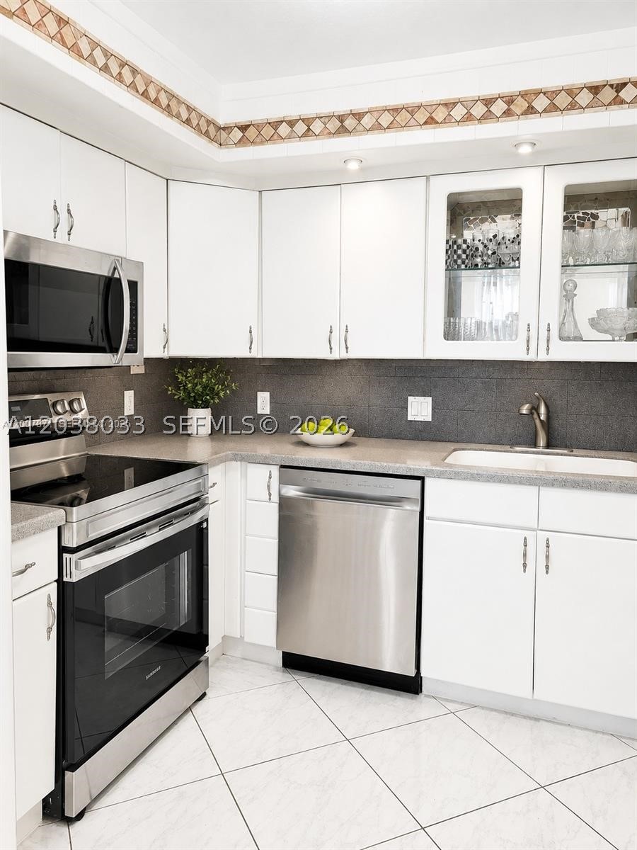 Beautiful lake views from your enclosed balcony! This lovely 2-bedroom, 2-bath condo on the 2nd floor has been freshly painted and features a new appliance. Tile flooring runs throughout the common areas, and the assigned parking space is conveniently located close to the elevator, with plenty of guest parking available. Enjoy resort-style living in Century Village, a 55+ community offering a fitness center, swimming pools, live shows, movies, bingo, card rooms, organized trips, tennis courts, and more.
