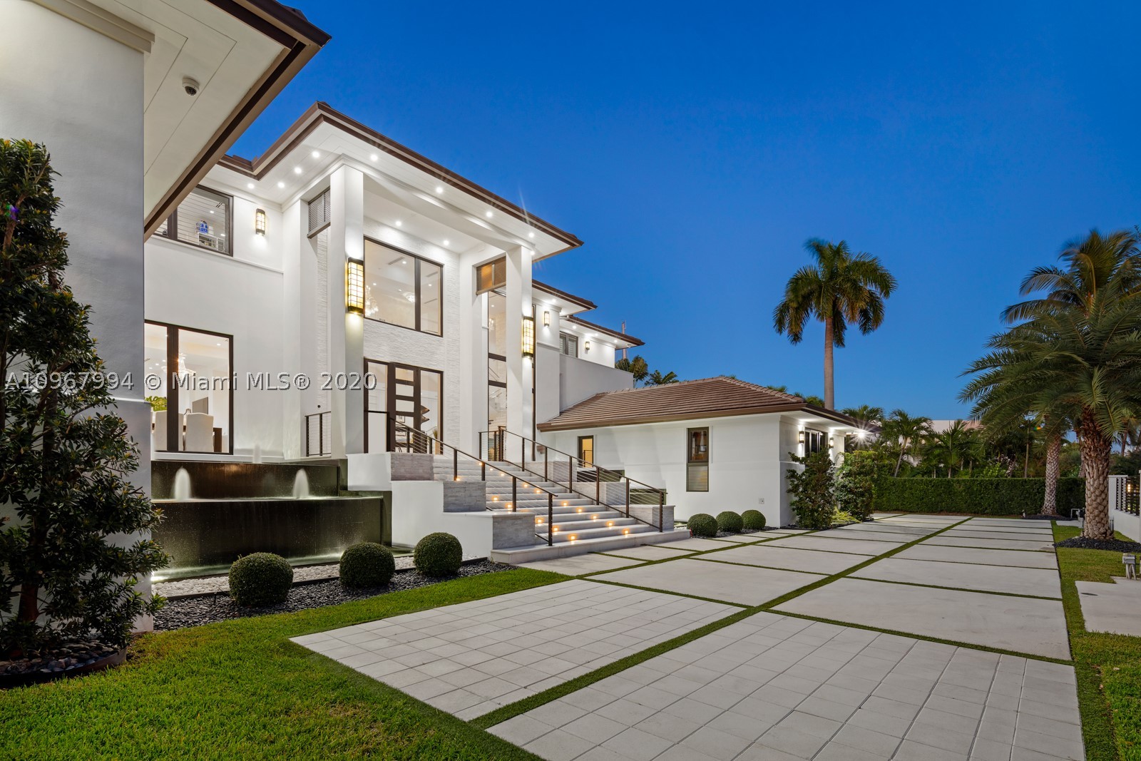 Elegant & grand waterfront estate in the gated community of Old Cutler Bay. This home stands out from the moment you enter the privacy gates, fascinating your eyes with stately architectural features and cascading water. Dramatic double-height foyer entrance, flowing water views. Enjoy a large eat-in, gourmet chef's kitchen adjoining bar and glass wine room or entertain at your outdoor kitchen area, covered terrace with retractable screen overlooking the heated saltwater pool & 142' seawall. Impressive large master suite with stunning bathroom, his & hers custom walk-in closets & walk-out balcony. Top level also has 2 en-suite guest bedrooms. Theatre/screening room plus 2 bedrooms on first level plus staff quarters. 3-car garage, elevator, whole house generator & under-home storage.