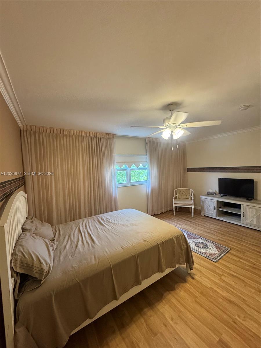Discover turn-key luxury in this beautifully reimagined 2-bedroom, 2-bathroom condo, offering over 1,200 sq. ft. of pristine, modernized living space in a premier 55+ Plantation community. This move-in-ready gem delivers total peace of mind with brand-new hurricane-impact windows and doors, fresh custom paint, upgraded baseboards, smooth textured finishes, and a high-end A/C unit featuring a 9+ year transferable parts-and-labor warranty. Inside, you'll find gorgeous vinyl wood flooring throughout, abundant closet space, and a chef’s kitchen complete with rich cabinetry, modern recessed lighting, and a stunning coffered ceiling. Relax on your fully converted, enclosed patio overlooking the serene garden, community pool, and BBQ areas, while enjoying the premium convenience of an assigned undercover parking space and a private downstairs storage unit. Best of all, the seller has partnered with Rate Leaf as the preferred lender to offer exclusive discounted interest rates and specialized 55+ financing programs, making this stunning lifestyle incredibly affordable—schedule your private tour today!