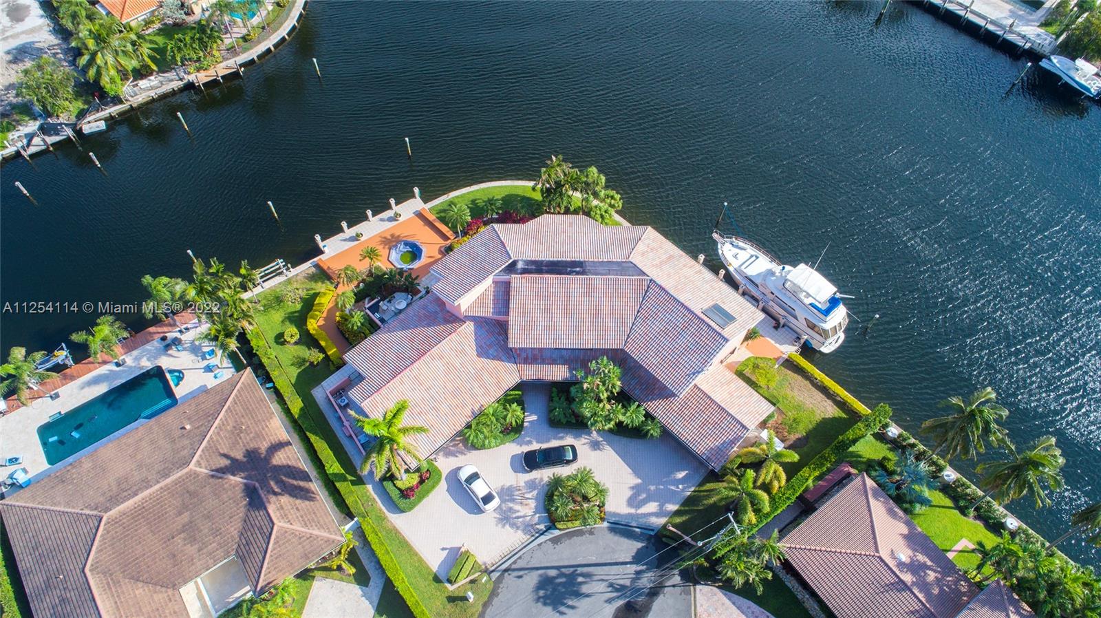 YACHTERS DREAM POINT LOT on 352' of seawall with ocean access ready for you to relax, take in the breathtaking full ocean and intracoastal views in this exclusive neighborhood of Golden Isles. Extraordinary double corner lot 19,261+ sq ft. waterfront lot!! Unique property beautifully maintained with 4 cars garage electric boat lift/dock for (2) yachts and patio areas, 4 Bedrooms and 4 bathrooms beautifully island kitchen with granite countertops soaring light filled entry atrium custom built-ins included. marble topped bar + dual living rooms formal dining room huge M. Suite with corner water views family room. Seller provides Finance. "This GEM property will not last".