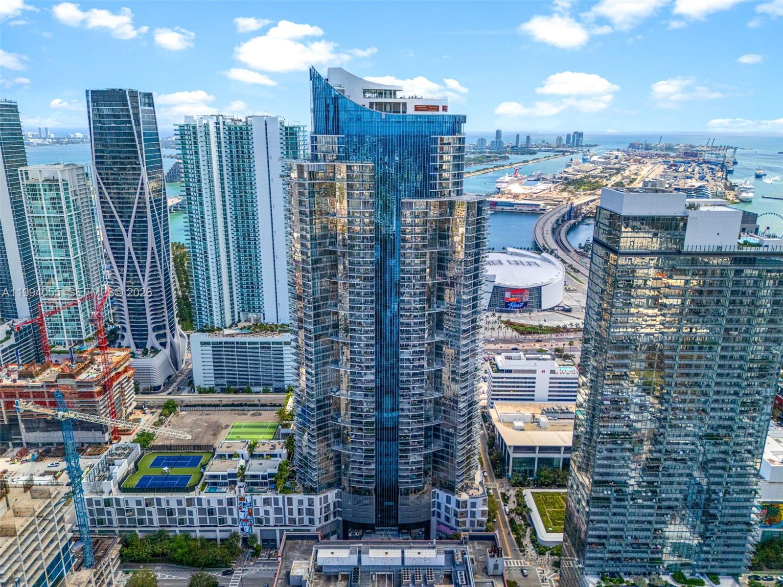 Experience the pinnacle of urban luxury in Unit 1205 at the world-renowned Paramount Miami Worldcenter. This sophisticated 1BR+Den/2BA residence features a private elevator foyer and 10ft ceilings. The versatile den, adjacent to a full bathroom, functions perfectly as a 2nd bedroom or home office. Designer finishes include a European kitchen with Sub-Zero/Wolf appliances and floor-to-ceiling glass leading to a spacious balcony. Paramount offers the "most amenitized building in the world" with a 6-acre deck: 5 pools, soccer field, tennis, boxing, state-of-the-art fitness, and a 55th-floor Skydeck with panoramic views. Perfectly positioned in the heart of Downtown, steps from the Brightline, Kaseya Center, and world-class dining. Live in the center of it all.