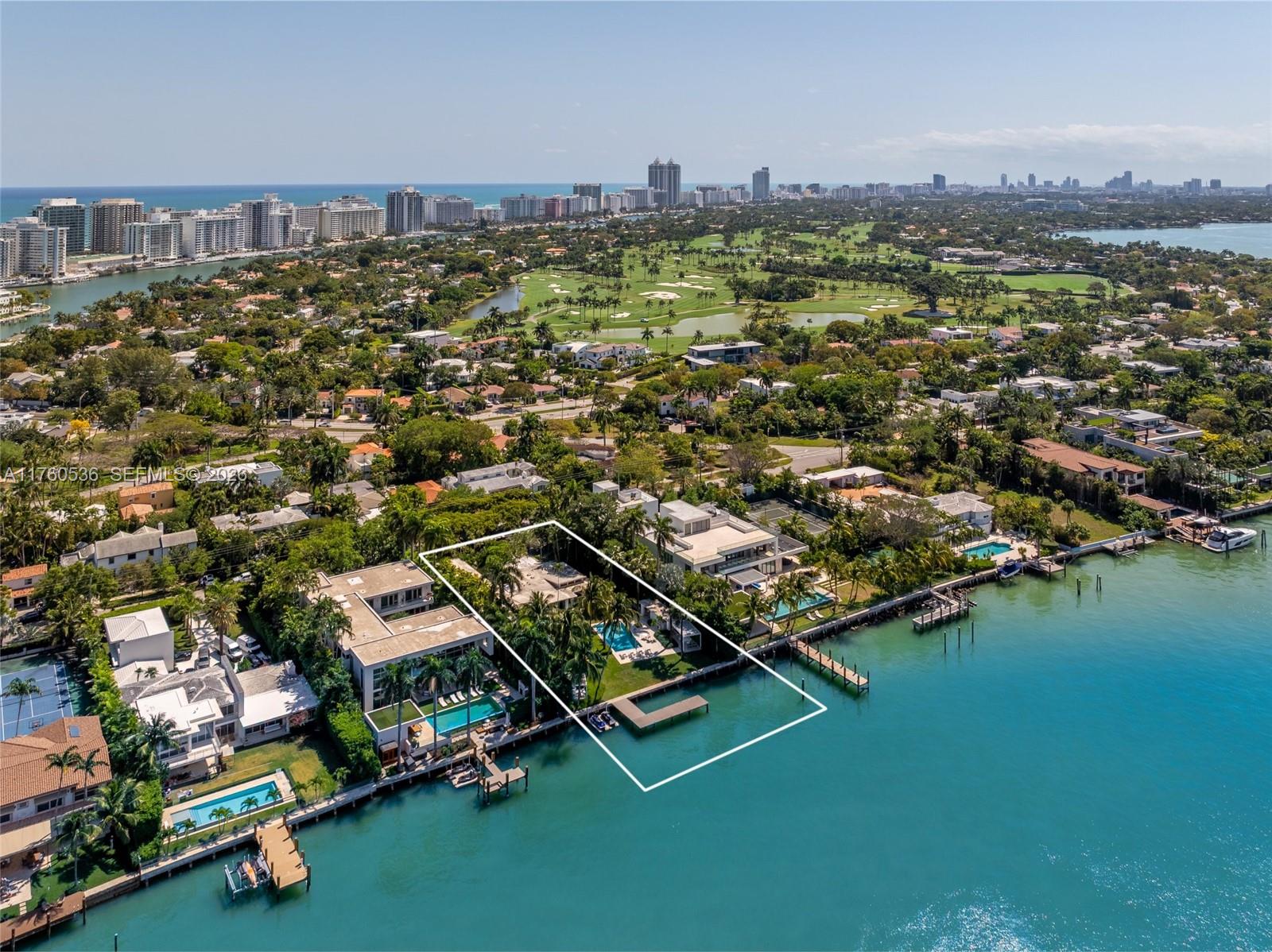Step into this breathtaking waterfront sanctuary on prestigious North Bay Road. This 4-bedroom, 4.5-bath mid-century estate sits on an oversized 27,013 SF lot w/ 113’ of pristine bay frontage. A grand koi pond entrance leads to sunlit interiors, featuring L-shaped living room, bar, private office, media room, & formal dining area. The fully renovated Bulthaup kitchen combines style & function w/ high-end appliances & a second prep kitchen. The primary suite mesmerizes w/ sweeping water views, dual walk-in closets & a luxurious spa bath. Outdoors complete w/ lush landscaping designed by Raymond Jungles, heated pool, dining & seating pavilions, private dock & a Kalamazoo built-in summer kitchen w/ pizza oven. This home blends privacy & serenity, moments from Miami Beach’s vibrant lifestyle.