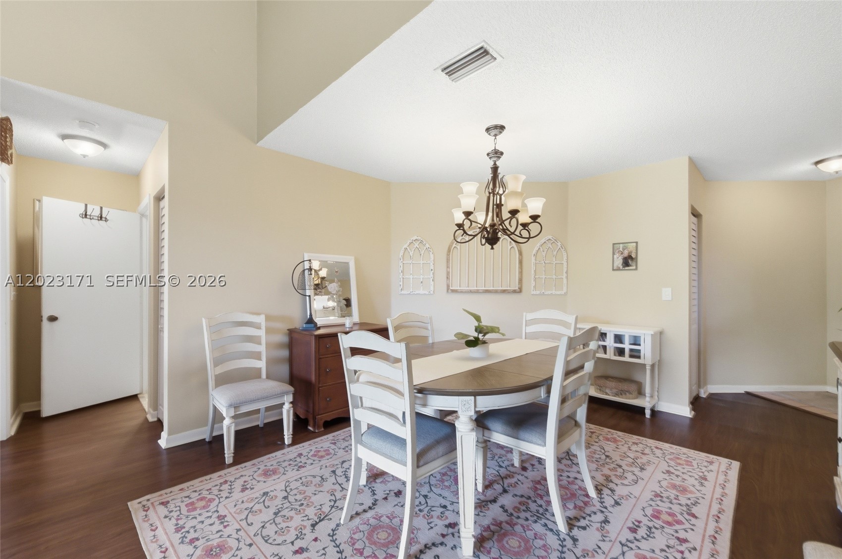 Stunning 2-Bed/2-Bath Condo Located In The Desirable Bayview Village Of The Township — TOP FLOOR W/ Easy Elevator Access! Bright & Spacious Open-Concept Layout Featuring Vaulted Ceilings & An Abundance Of Natural Light Throughout. Rich Laminate Wood Flooring Flows Seamlessly Through The Living & Dining Areas, Complemented By Direct Access To The Private Screened-In Balcony— The Perfect Spot To Enjoy Peaceful Treetop Views W/ Morning Coffee & Which Features a Full Size Washer and Dryer. The Updated Eat-In Kitchen Impresses W/ Rich Wood Cabinetry, Granite Countertops, SS Appliances. Dining Area Features An Elegant Chandelier & Plenty Of Space For Entertaining. The Spacious Primary Suite Offers A Ceiling Fan, Direct Balcony Access, Ample Natural Light, & A Walk-In Closet. The En-Suite Primary Bathroom Showcases An Expansive Wraparound White Vanity, Abundant Counter & Storage Space, & A Walk-In Shower. Second Bedroom Also Includes A Ceiling Fan & Comfortable Closet Space — Perfect As A Guest Room Or Home Office. The Second Full Bathroom Features A Clean White Vanity & Shower/Tub Combination. The Unit Is Equipped W/ Impact Windows & Accordion Shutters For Complete Hurricane Protection, Plus A Brand New 2025 AC System W/ A Smart Thermostat For Year-Round Comfort & Efficiency. Perfectly Located Less Than 5 Minutes From The Promenade W/ Endless Shopping & Restaurants. This One Has It All — Schedule Your Showing Today!