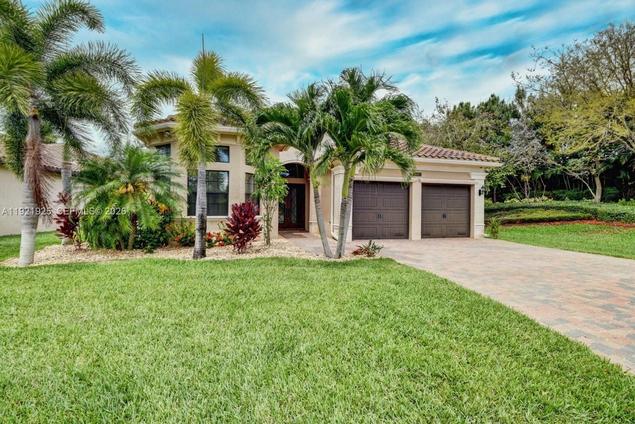 MAJOR PRICE IMPROVEMENT! Nestled in the guard-gated, resort-style Bridges of Delray, this single-story Paseo model, built in 2014 and hardly lived in, is in like-new condition on a rare private ¼-acre corner lot with no neighbors to the right, behind, or directly in front. Meticulously maintained, the home features 3 bedrooms, 3.5 baths, plus a large den/office with windows and a door (can be used as a 4th bedroom), gourmet kitchen with 2 islands, upgraded appliances, wet bar, porcelain and bamboo floors, central vacuum with kitchen sweep, hurricane-impact windows and doors, and a whole-house generator connected to the city’s natural gas supply for seamless, unlimited runtime during any outage. Living spaces flow to the outdoors with a heated whirlpool pool with dual pump system, covered screen-enclosed patio, cabana bath, outdoor shower, and extra-long paver driveway on a professionally landscaped ¼-acre lot with automatic HOA sprinklers. Architectural exterior lighting highlights the home’s design and mature landscaping at night. Residents enjoy resort-style amenities including clubhouse, fitness center, Har-Tru clay tennis courts with tennis pro, indoor/outdoor basketball, resort pool and hot tub, poolside restaurant, yoga studio, sauna, splash pad, and playground. Just 3 miles to Delray Marketplace and 12 miles to the ocean. Move-in ready, this home blends privacy, luxury, and resort-style living.