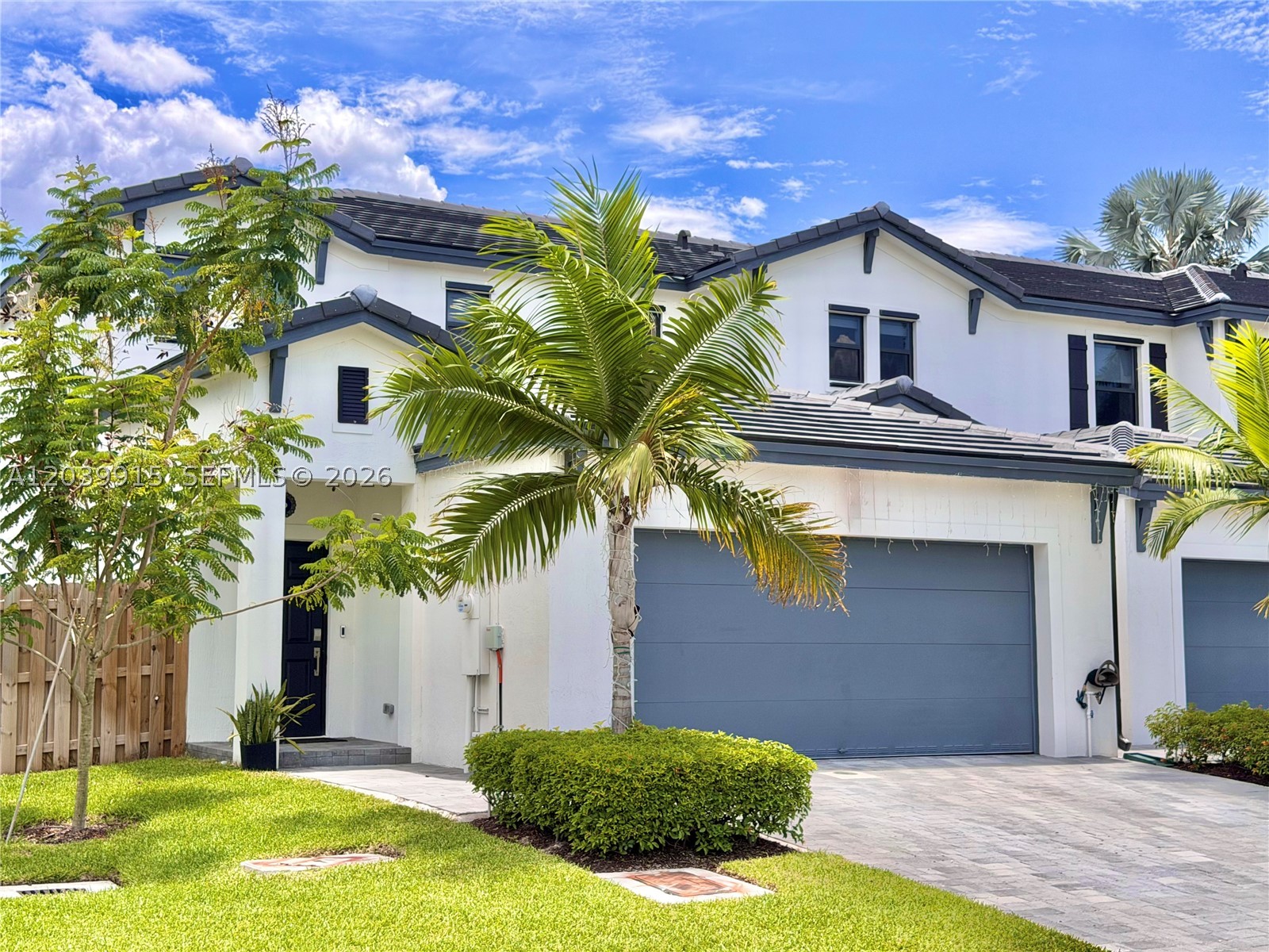 Welcome to your dream home in the exclusive gated community of Dania Preserve! This spectacular corner townhome, with only a year and a half of construction, blends modern luxury and comfort. Enjoy a stunning lake view right in front of your home. Featuring a unique layout,  the primary bedroom and a full bathroom on the first floor. The second level features two spacious bedrooms, a bathroom, an a large den ideal for family entertainment. The property stands out for its exquisite upgrades: 2-car garage with an immaculate epoxy floor, motorized blinds on the first floor, elegant wallpaper in the living room, beautifully renovated bathrooms, modern laminate flooring, and designer lighting fixtures. The backyard features low-maintenance artificial turf, perfect for relaxing. Ideally located just minutes from the beach, supermarkets, the Hard Rock Hotel, and premier shopping malls. Enjoy a boutique community of only 67 homes with resort-style amenities. A true gem ready to move in!
