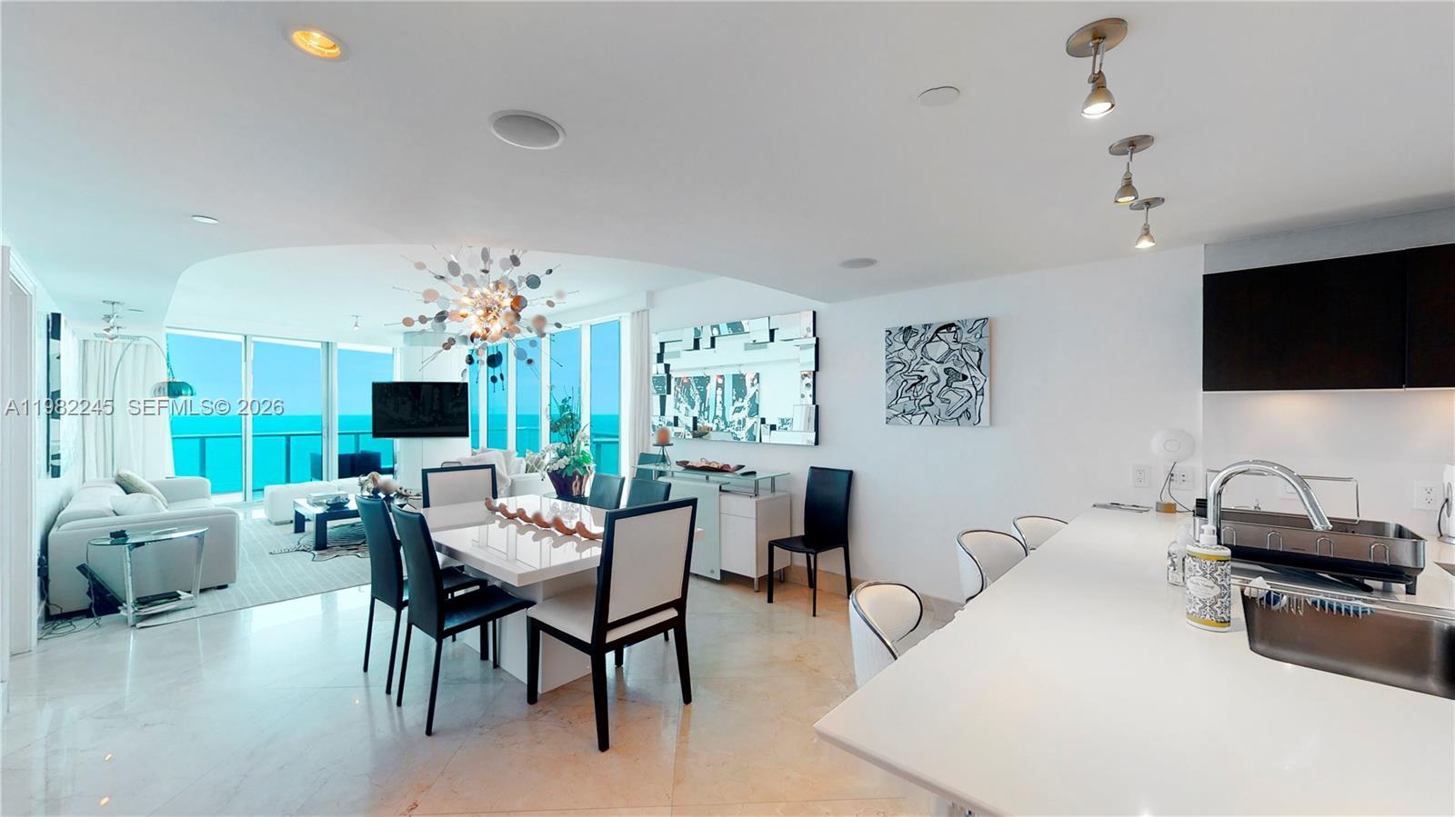 PRICED TO SELL!!! Welcome to this exceptional Southeast corner residence, where breathtaking sunrise and sunset views are showcased through expansive wraparound terraces facing both east and west. Elegantly designed with sophisticated interiors, this home features premium appliances, automated shades, and seamless flow throughout. The spacious open kitchen invites both quiet mornings and elegant entertaining. Indulge in a five-star lifestyle with a full-service spa, oceanfront fitness center with cardio, spinning, and Pilates studios, and a stylish poolside café serving your favorite snacks and drinks.