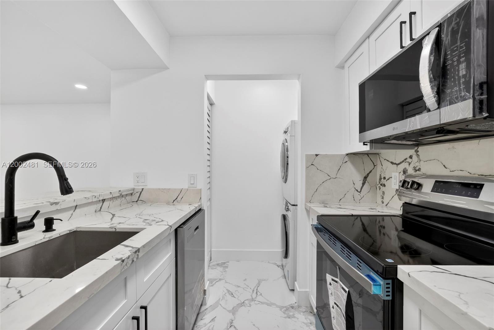 Beautifully renovated and move-in ready 1-bedroom, 1-bath condo in the heart of Pompano Beach! This unit has been substantially upgraded with a modern, clean design throughout, featuring elegant large-format porcelain tile flooring, a fully remodeled kitchen with quartz-style countertops, sleek white cabinetry, and all brand-new stainless steel appliances.

The open layout offers bright living spaces that flow seamlessly, enhanced by contemporary finishes, recessed lighting, and a stylish ceiling fan. The bathroom has been completely updated with a modern vanity, designer fixtures, and a glass-enclosed shower with custom tile work, creating a spa-like feel.

Additional features include in-unit washer and dryer, ample storage, and assigned parking. The community offers peaceful lake views, walking paths, and great amenities in a well-maintained setting.

Conveniently located just minutes from major highways, shopping, dining, and a short drive to the beach. A turnkey opportunity perfect for end users or investors looking for a fully upgraded unit in a desirable location.