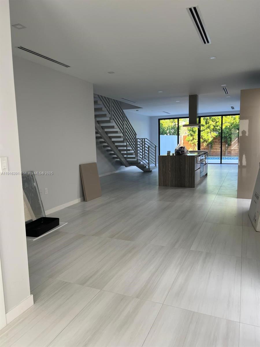Stunning new-construction 4BD / 3BA modern townhome with 2,400 sqft of luxury living on a 3,300 sqft lot in Shenandoah. Bright open floor plan with large-format porcelain tile, high ceilings, floating staircase, and floor-to-ceiling impact glass leading to a private backyard with a new pool and wood privacy fence. The Italian-designed kitchen features a waterfall island, custom soft-close cabinetry, premium finishes, and integrated appliances. All bedrooms upstairs, including a spacious primary suite with dual sinks, separate tub and shower, and walk-in closet. Home includes impact windows/doors, laundry room, attached garage, and energy-efficient systems. Centrally located minutes from Brickell, Coconut Grove, Coral Gables, and Coral Way.